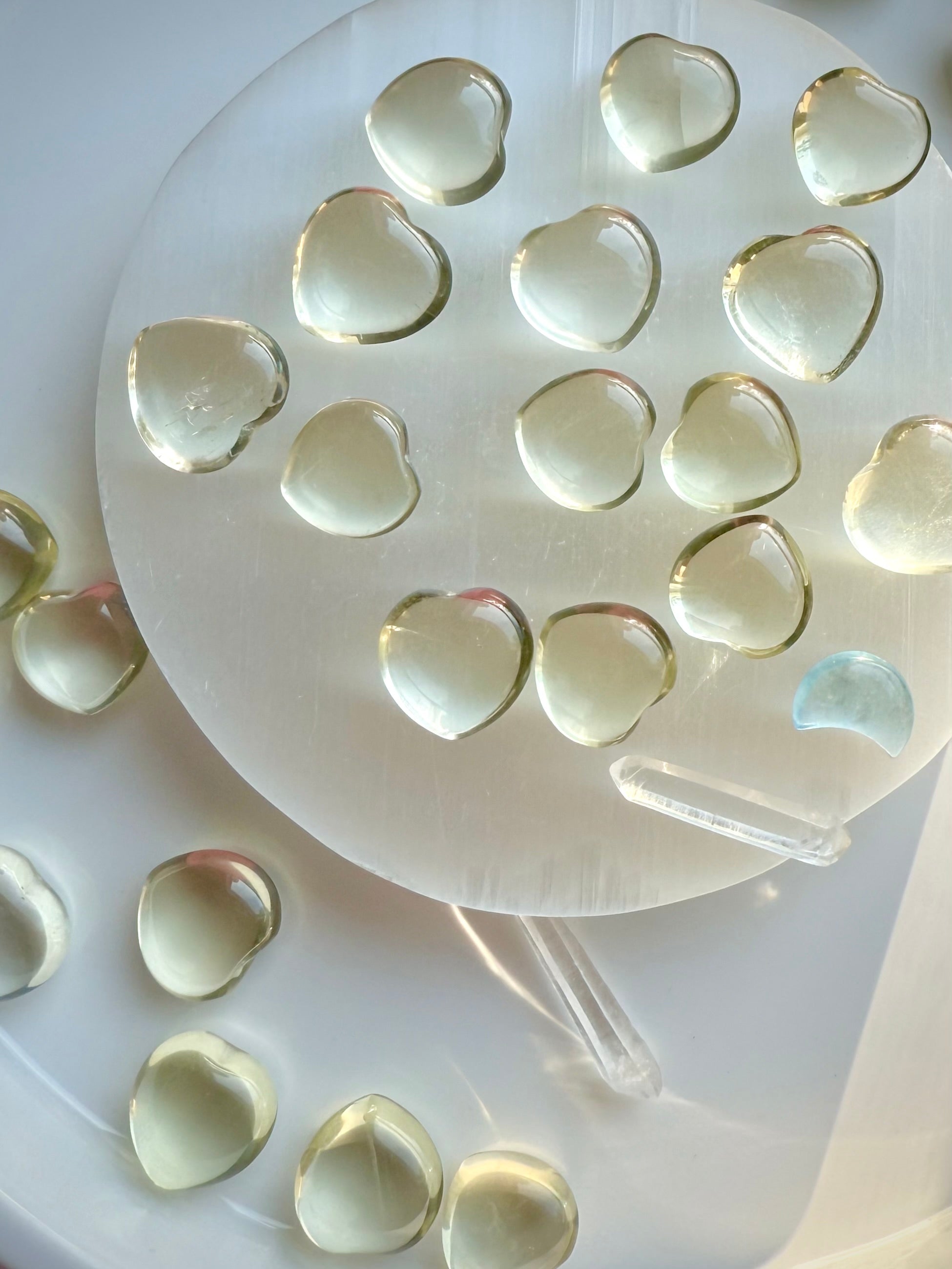 Mini Lemon Citrine heart crystals arranged on a selenite plate, uplifting yellow gemstone hearts for positivity and confidence