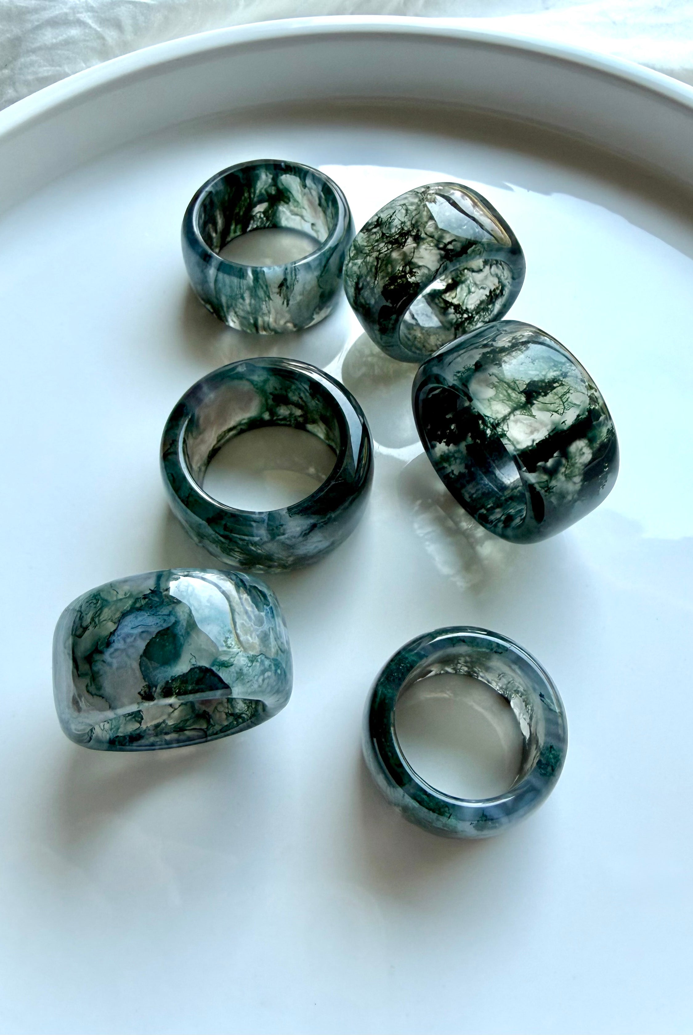 translucent moss agate statement rings with smoky green dendritic patterns and substantial rounded band design