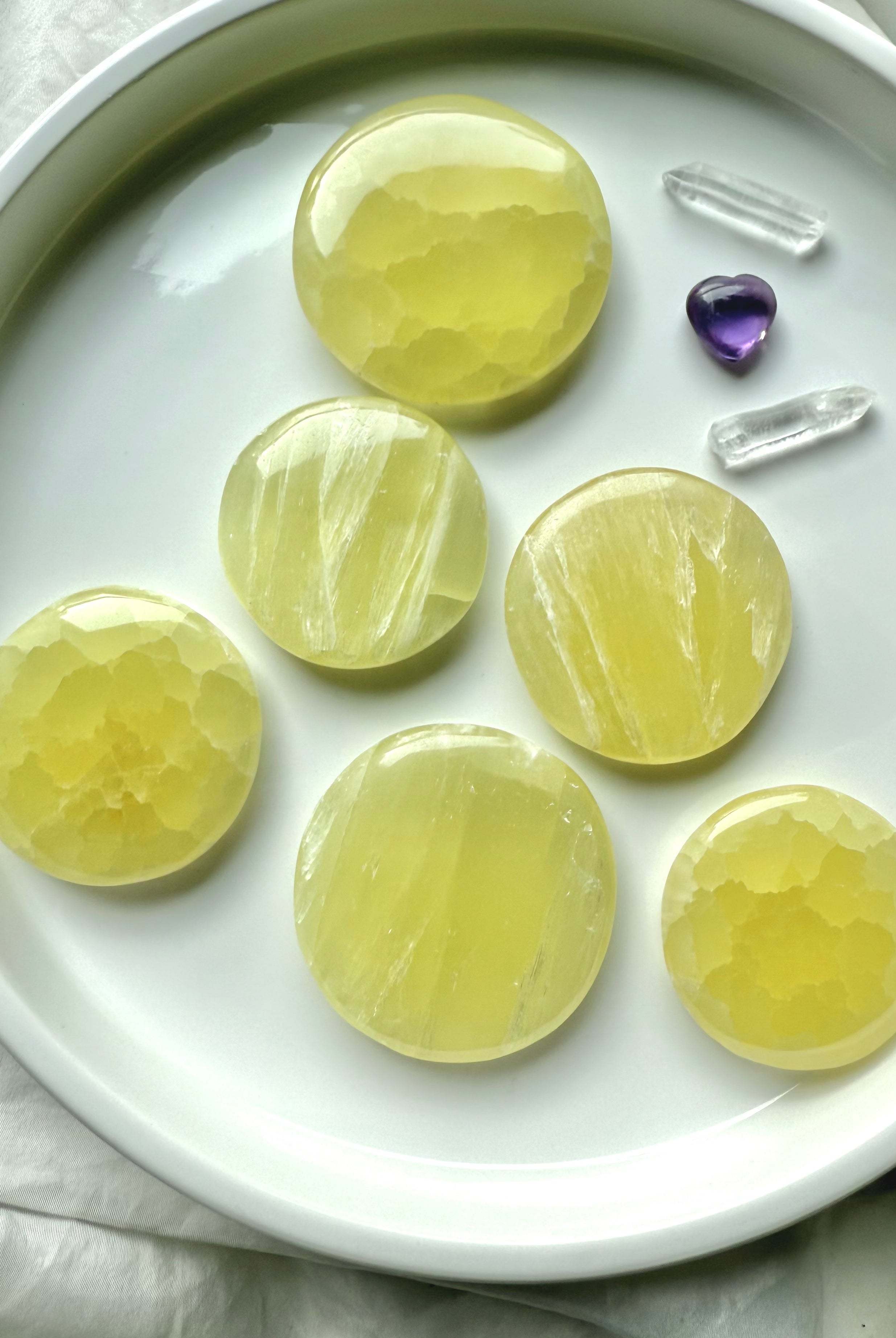 Assortment of lemon calcite crystal discs with amethyst and clear quartz accents
