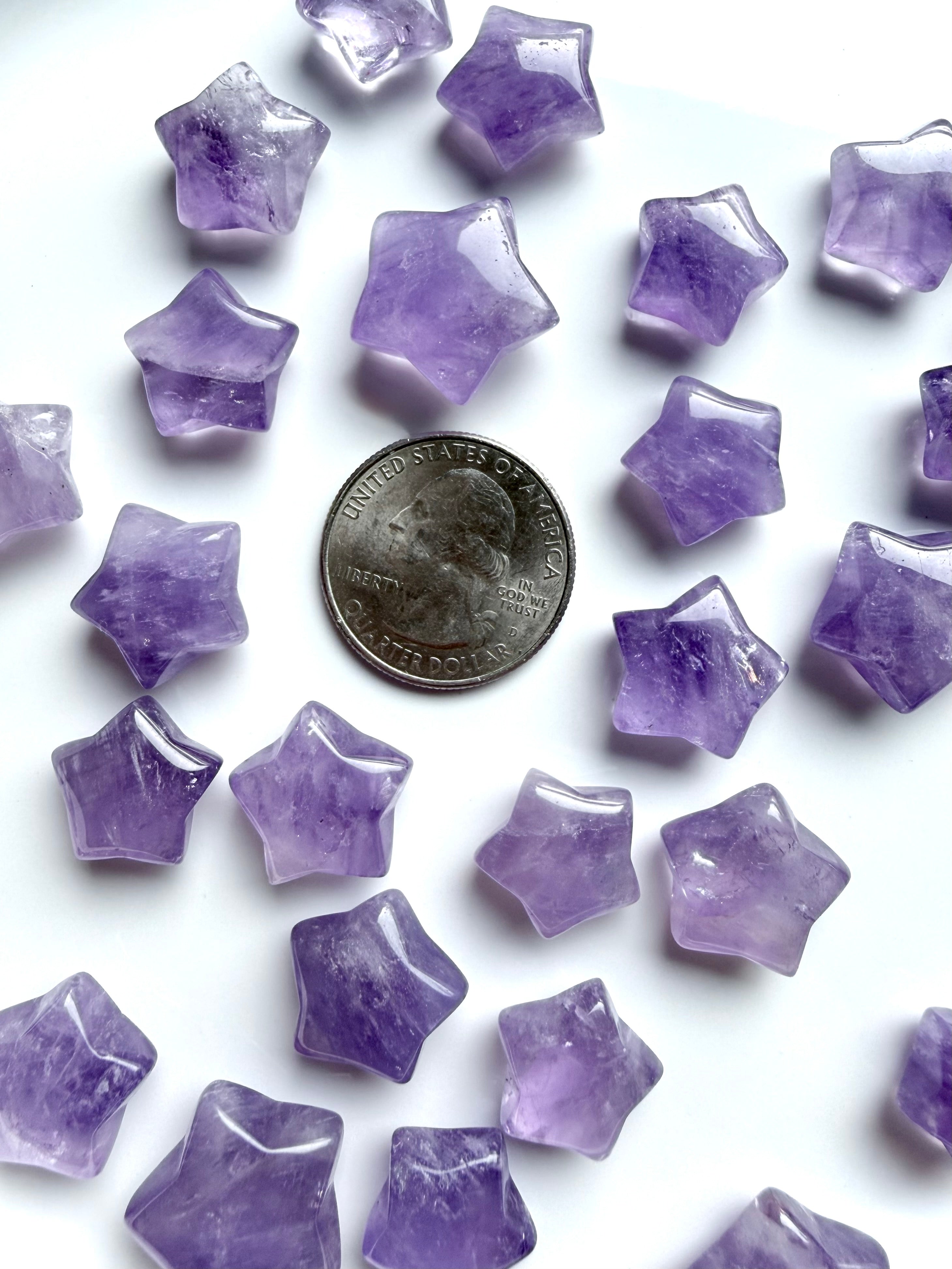 Mini Amethyst star carvings shown with quarter for size reference, small polished crystal stars for grids and pocket stones