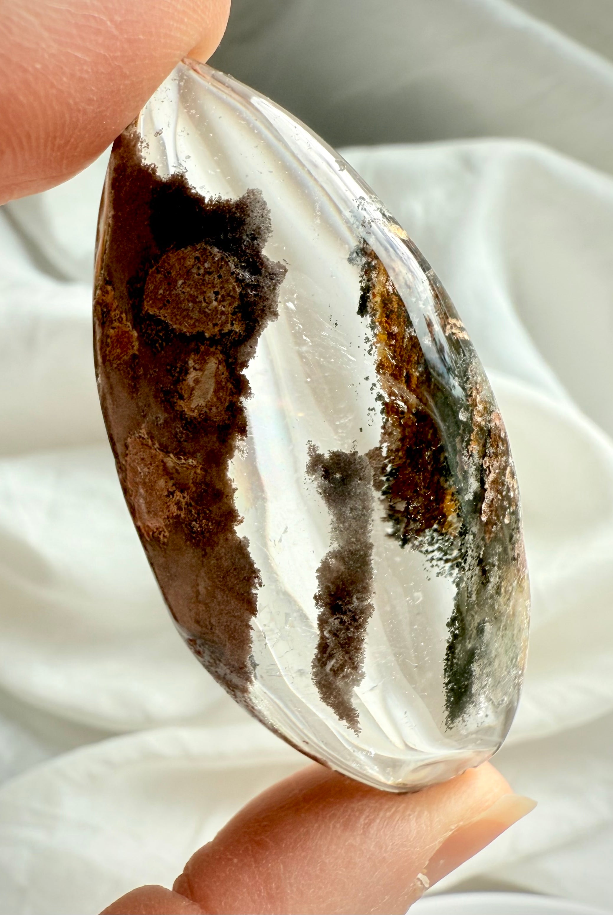 Back view of Garden Quartz lens with natural inclusions, texture, and polished edges