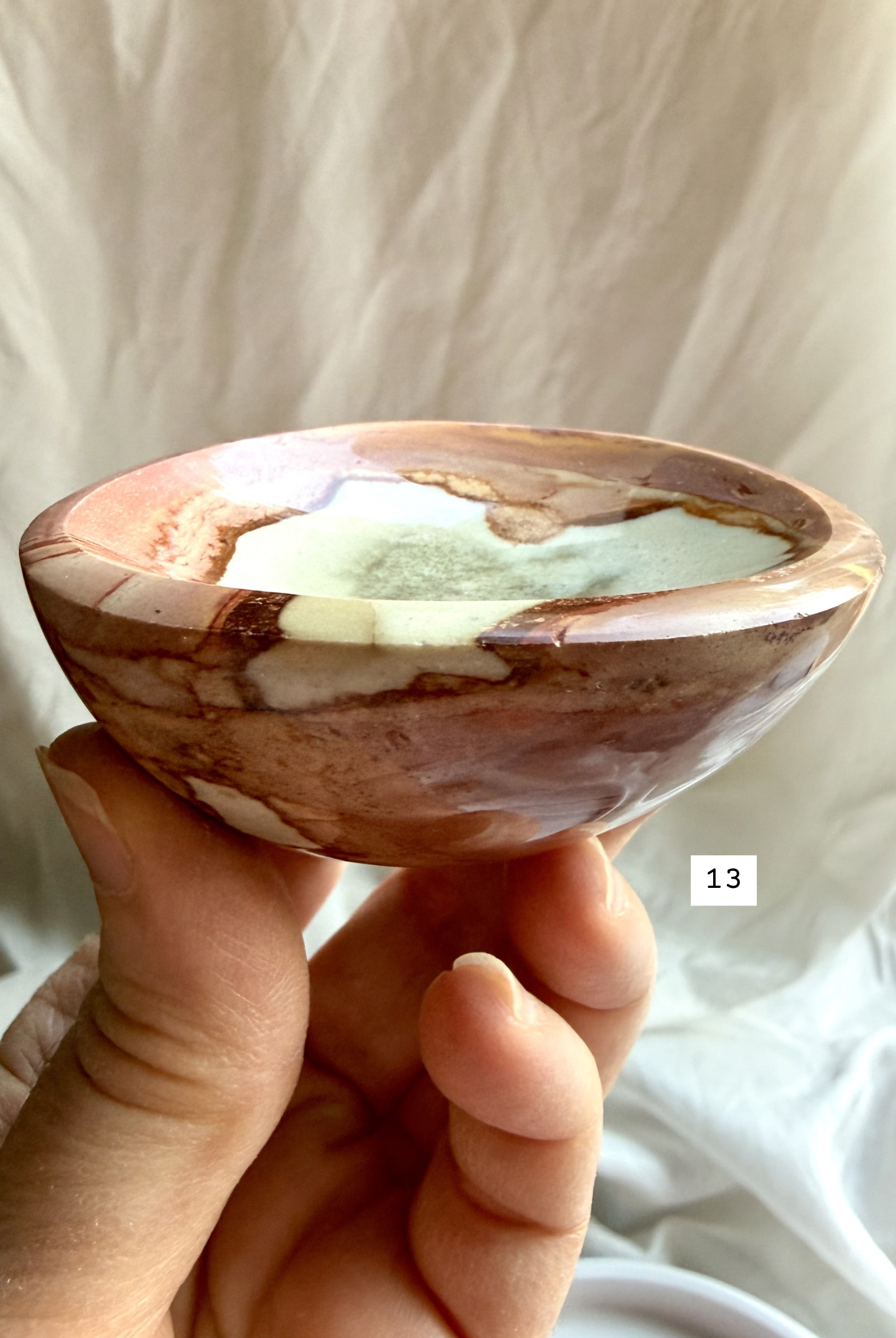 polychrome jasper crystal bowl held in hand side view natural stone dish showing depth and polished edge