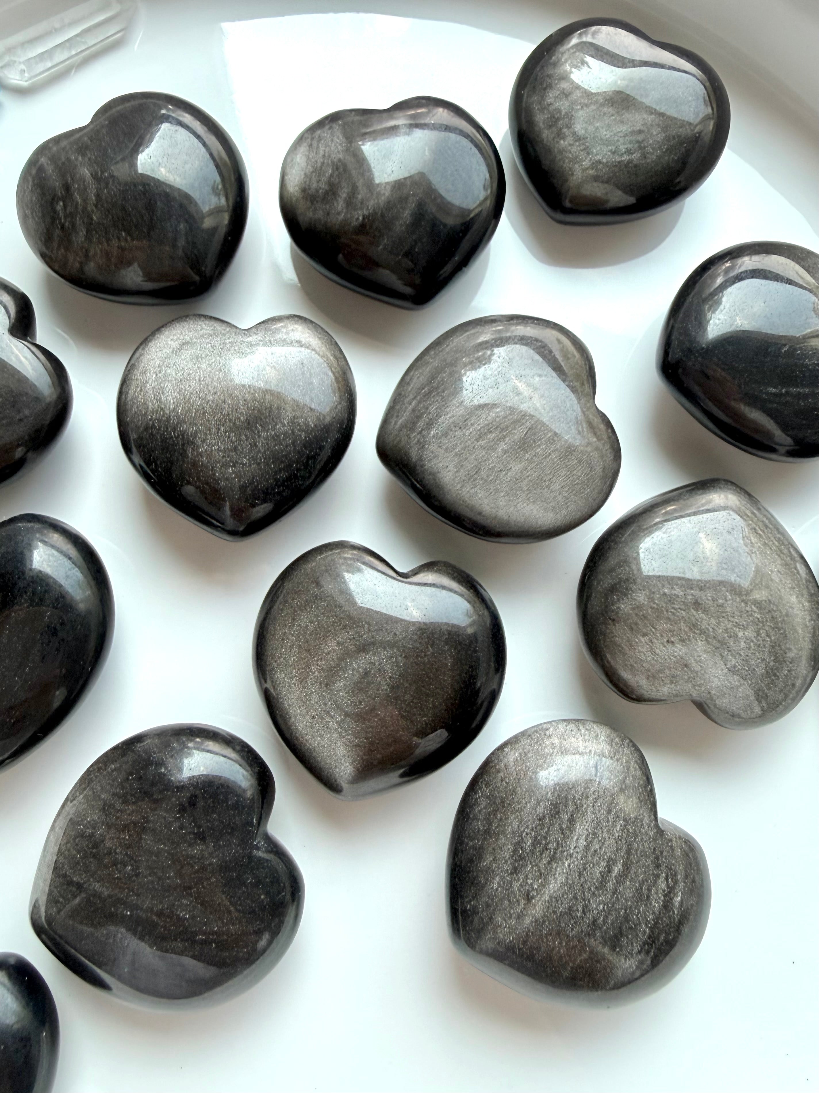 Silver Sheen Obsidian heart carvings showing unique gray, black and silvery reflective patterns