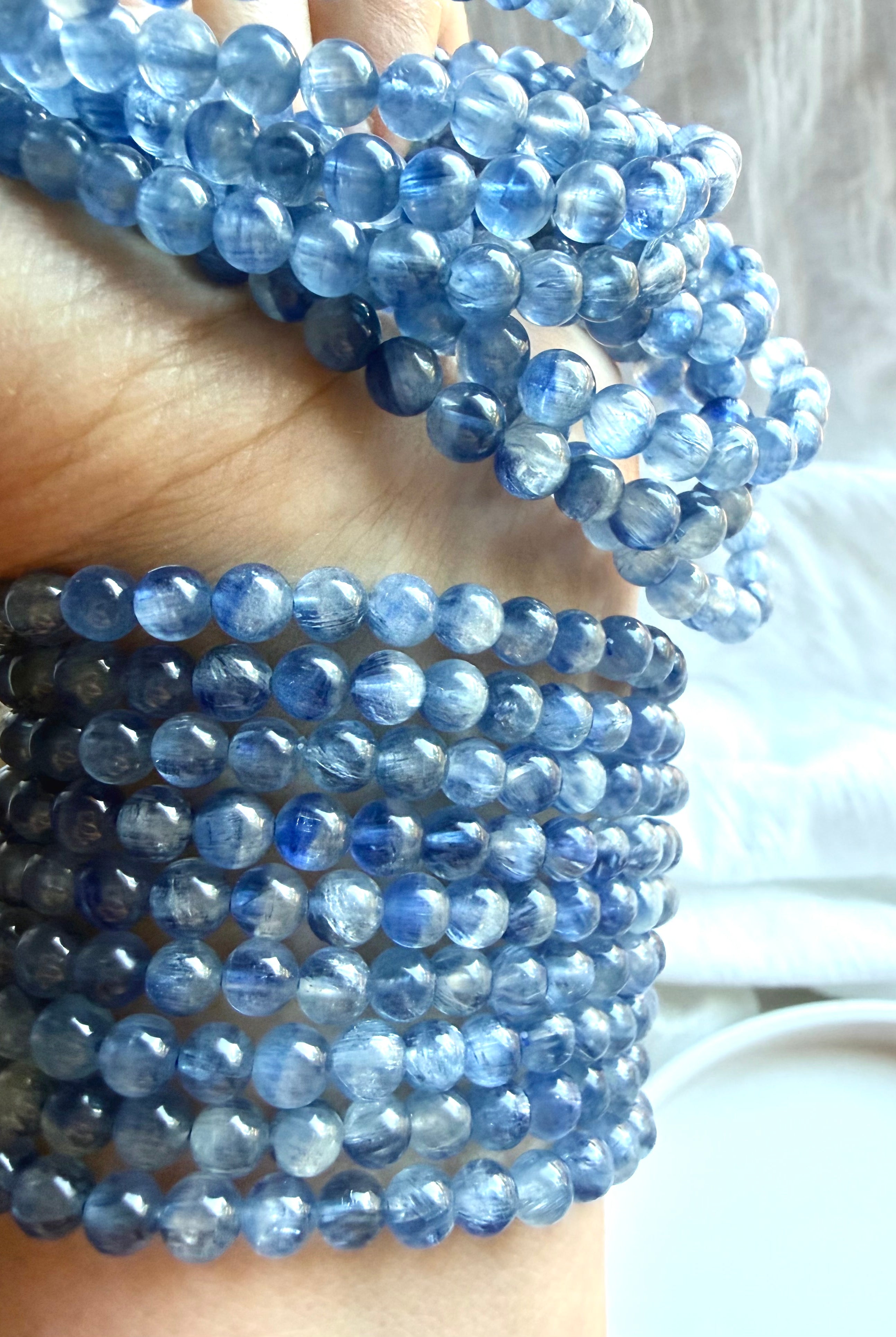 Blue Kyanite gemstone bracelets stacked together to show natural color variation and silky texture