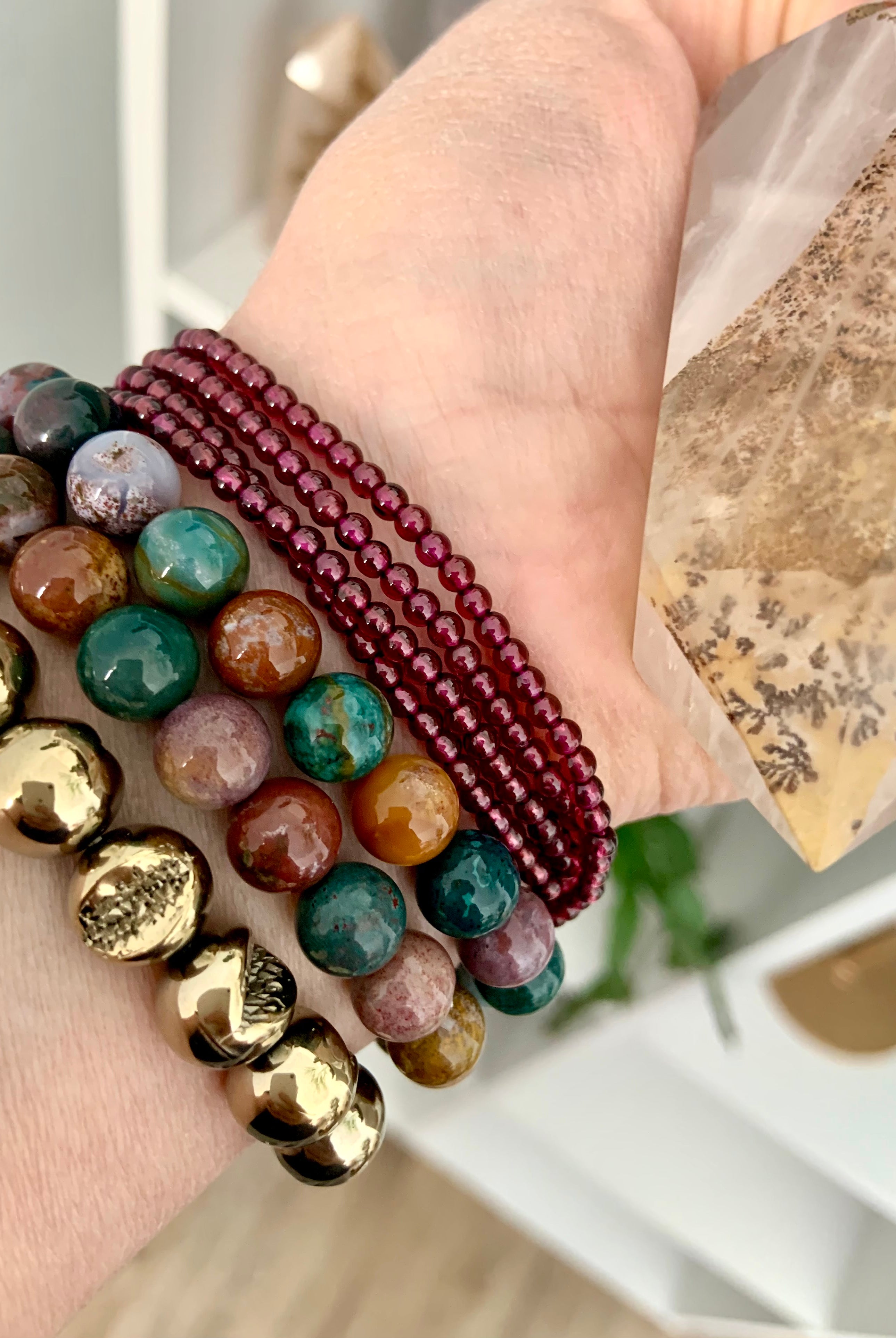 Pyrite bracelet worn with Ocean Jasper & Garnet bracelets — crystal stack for grounding, emotional balance & abundant energy.