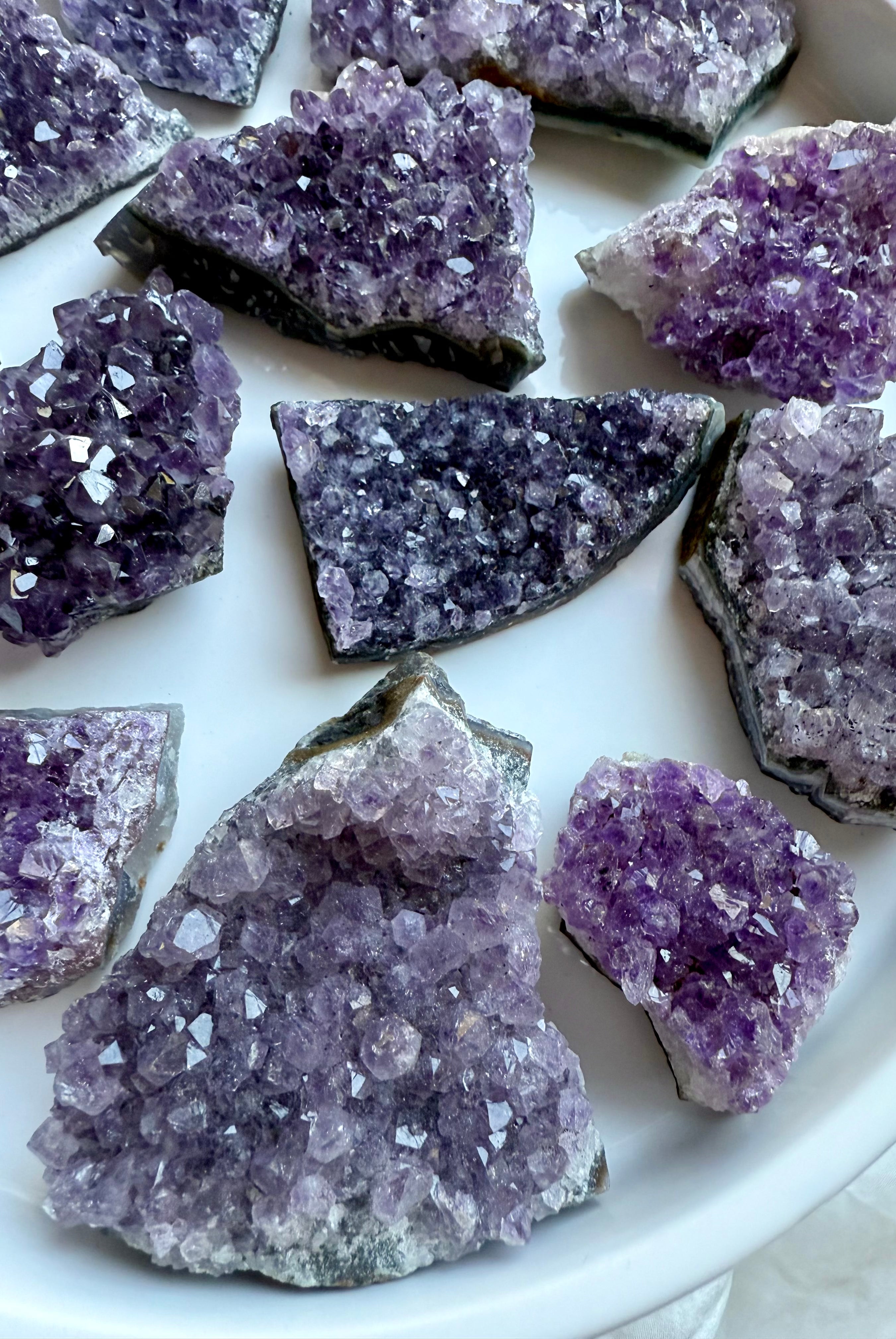 Closeup of small amethyst geode clusters with rich purple sparkle