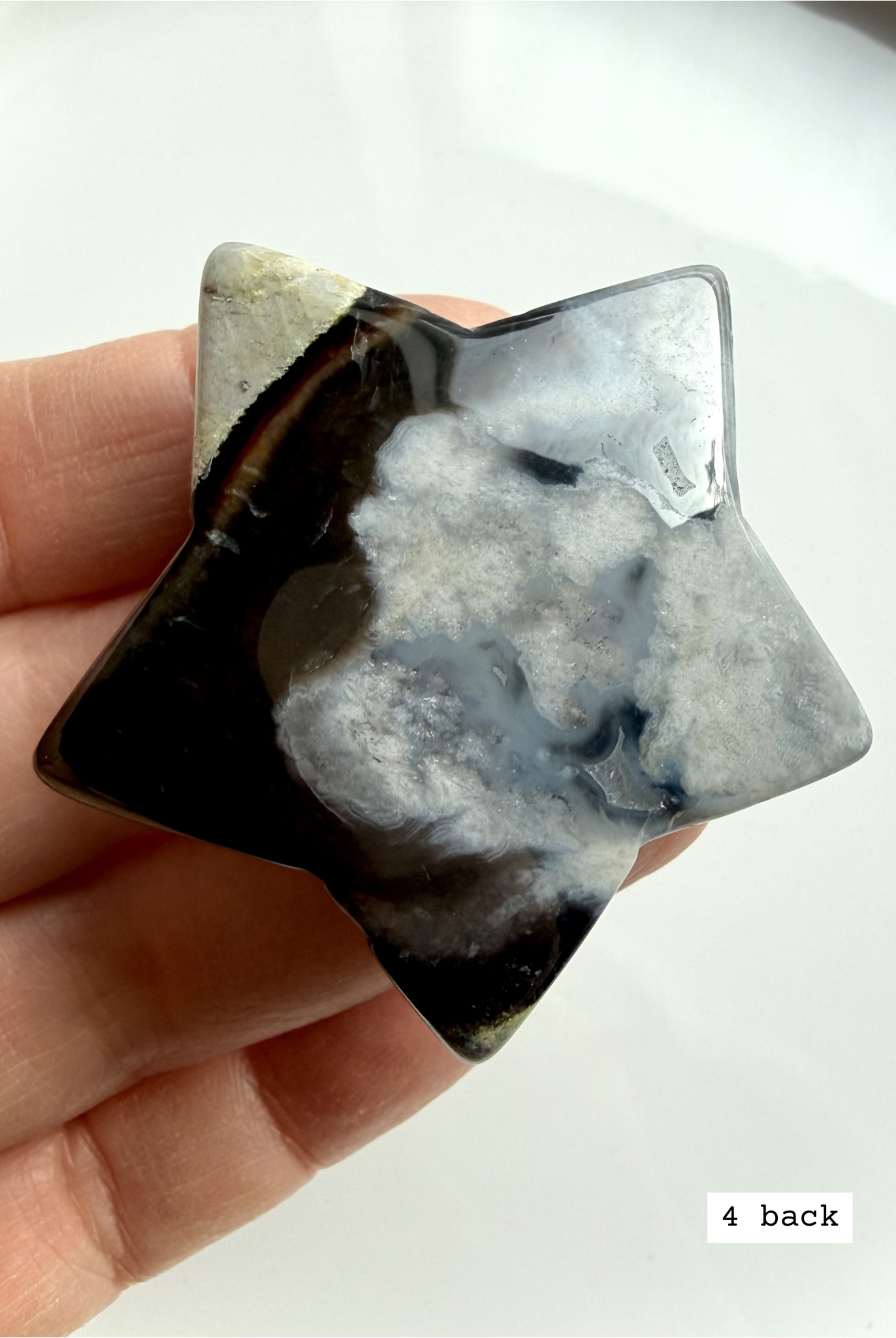 black flower agate star carving #4 back showing softer plume formations and polished stone texture