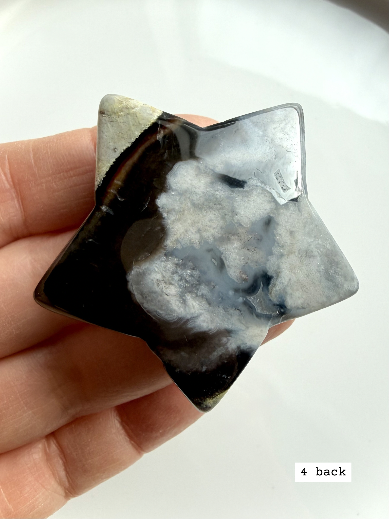 black flower agate star carving #4 back showing softer plume formations and polished stone texture