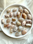High quality pastel Flower Agate tumbled stones with beautiful color patterns shown on a white plate