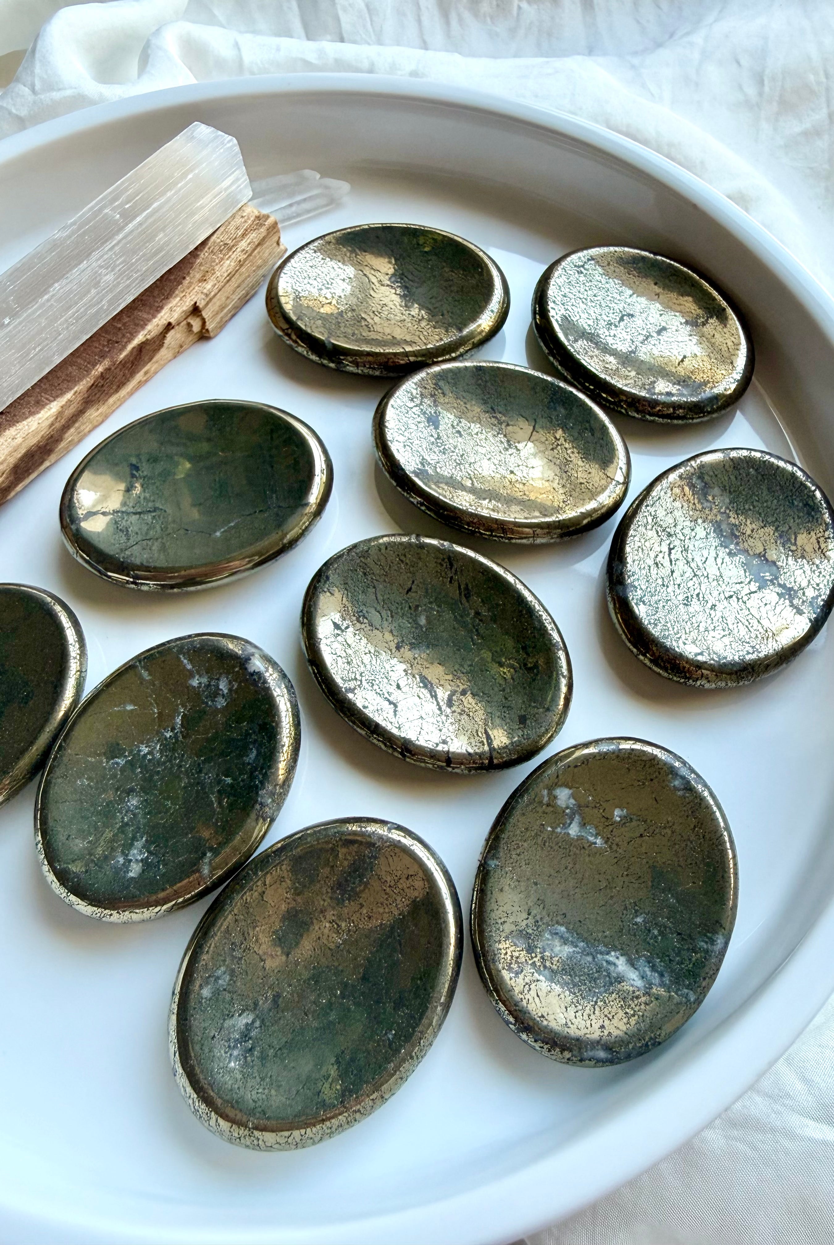 Oval Pyrite worry stones with metallic gold luster and varied natural inclusions for meditation and grounding
