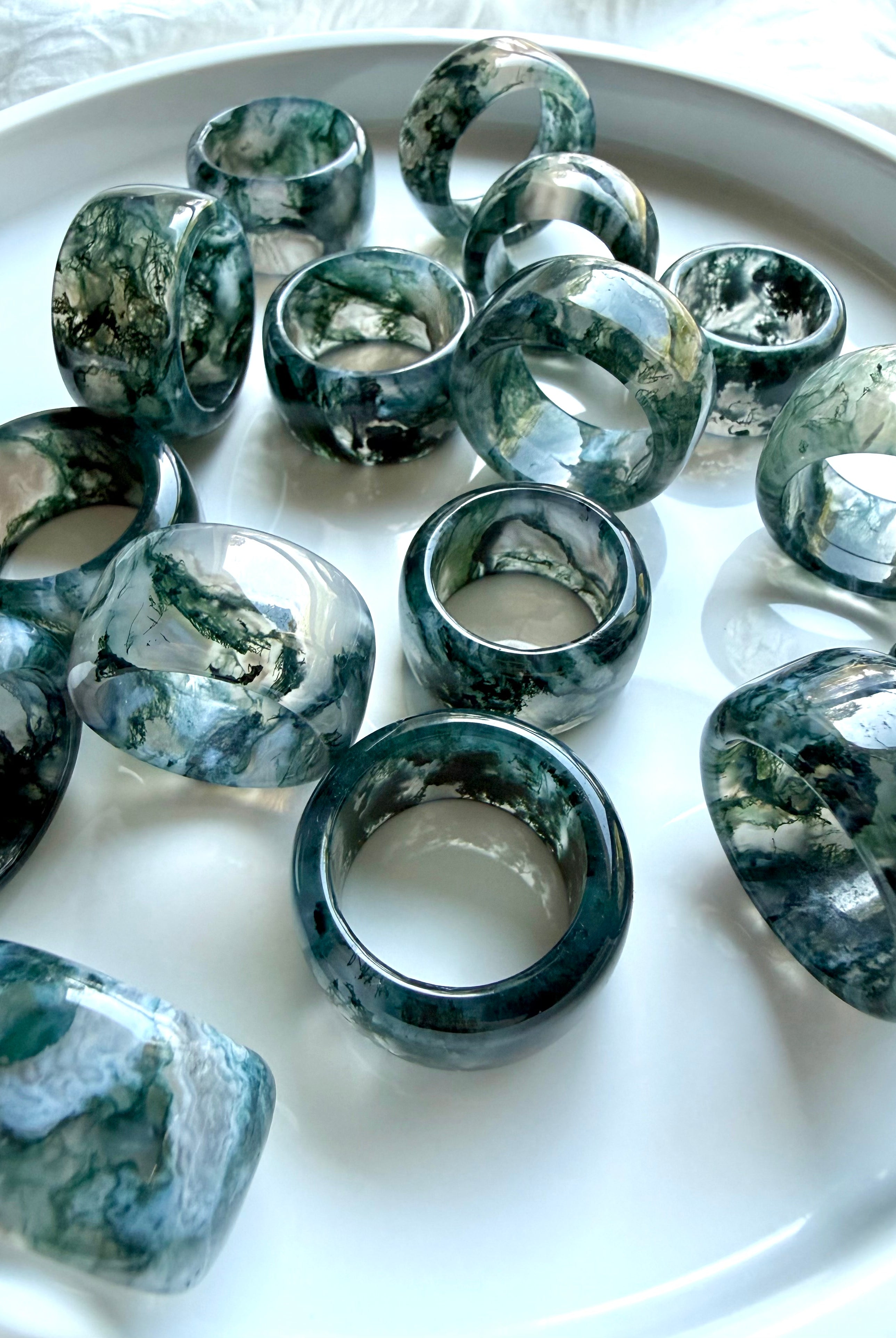 chunky translucent moss agate statement rings with scenic green inclusions and glossy rounded band style