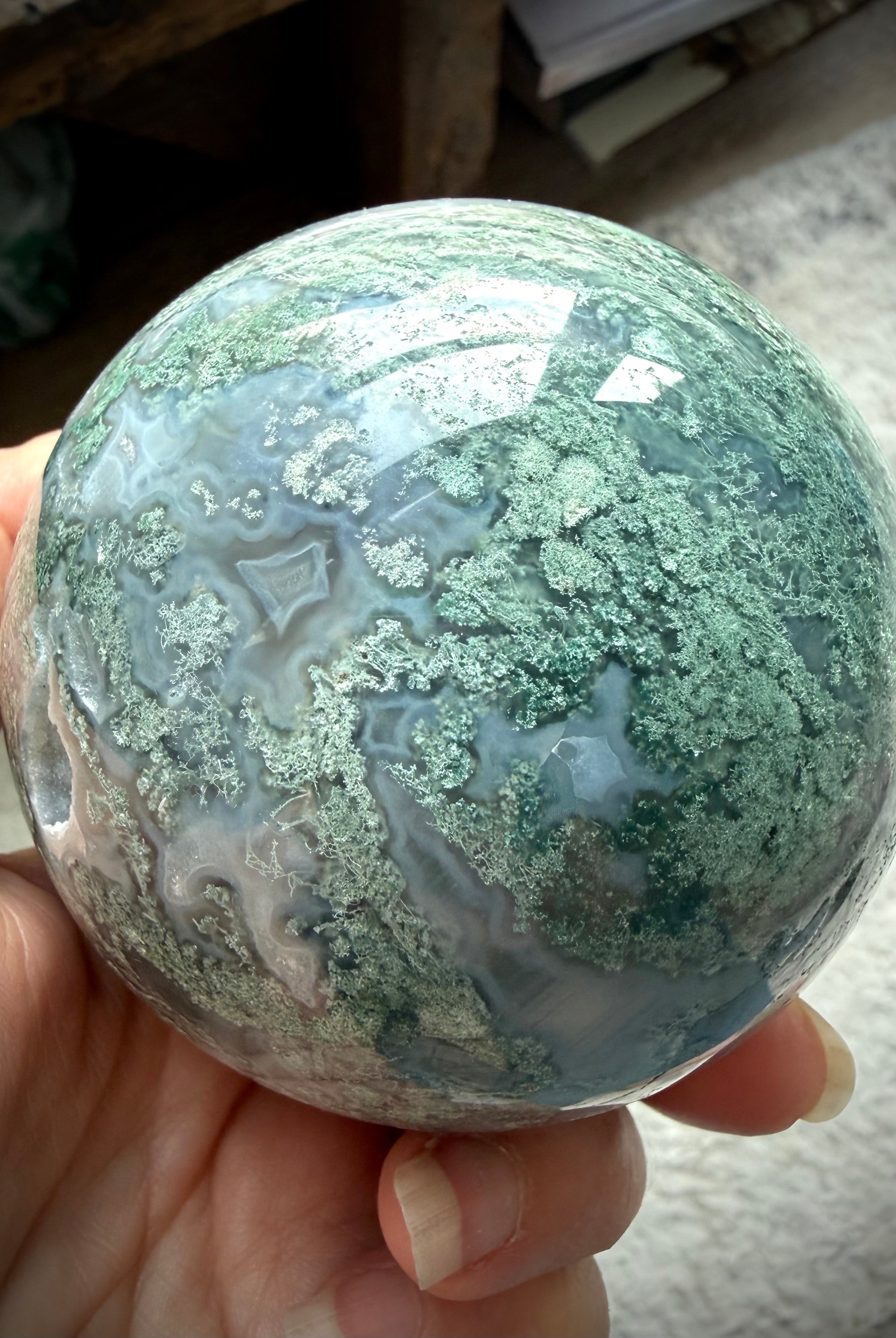 Druzy Moss Agate sphere showing polished crystal details, Quartz veins, and earthy green inclusions