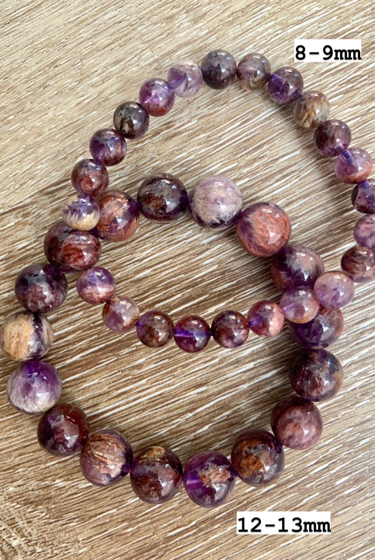 Two Super Seven crystal bracelets marked with bead sizes, showing natural amethyst & reddish inclusions