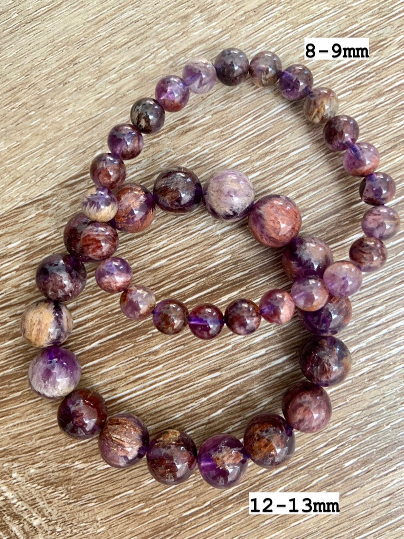 Two Super Seven crystal bracelets marked with bead sizes, showing natural amethyst & reddish inclusions