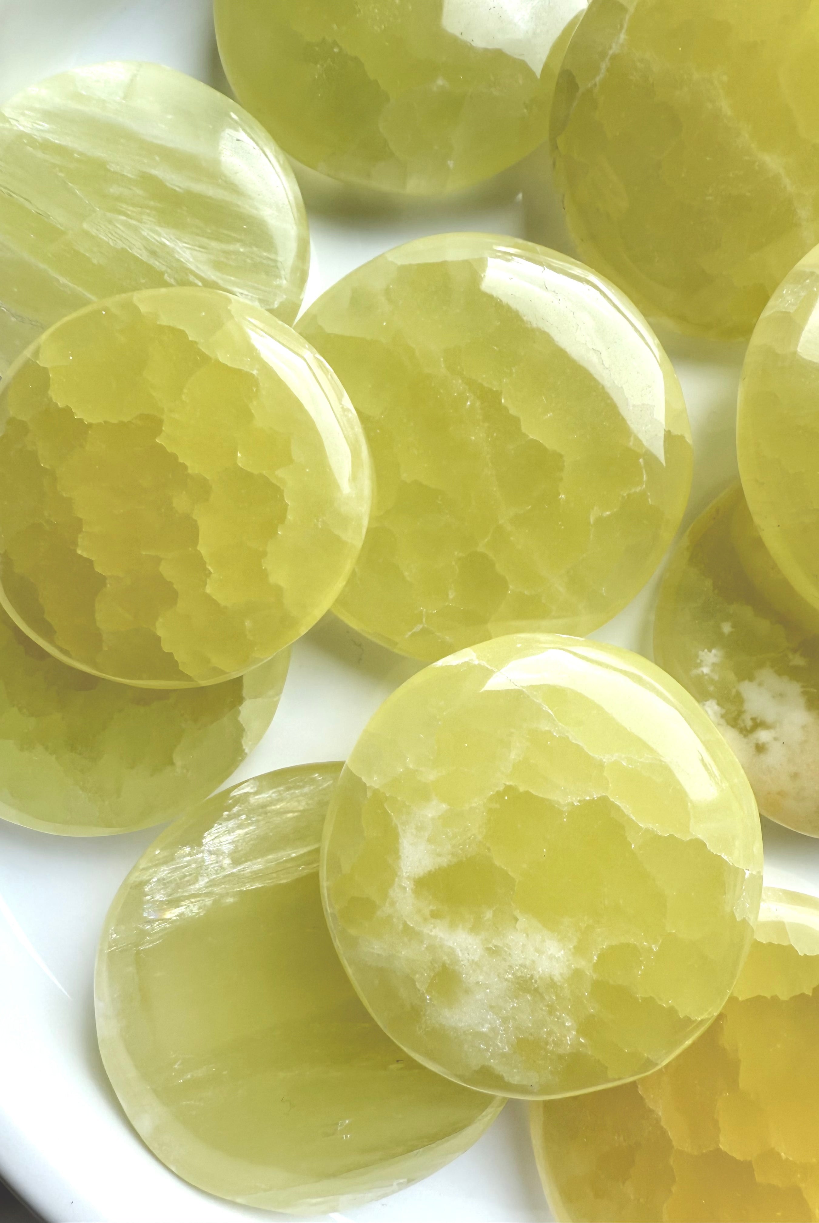 Cluster of lemon calcite stones with glowing translucent quality and organic veining