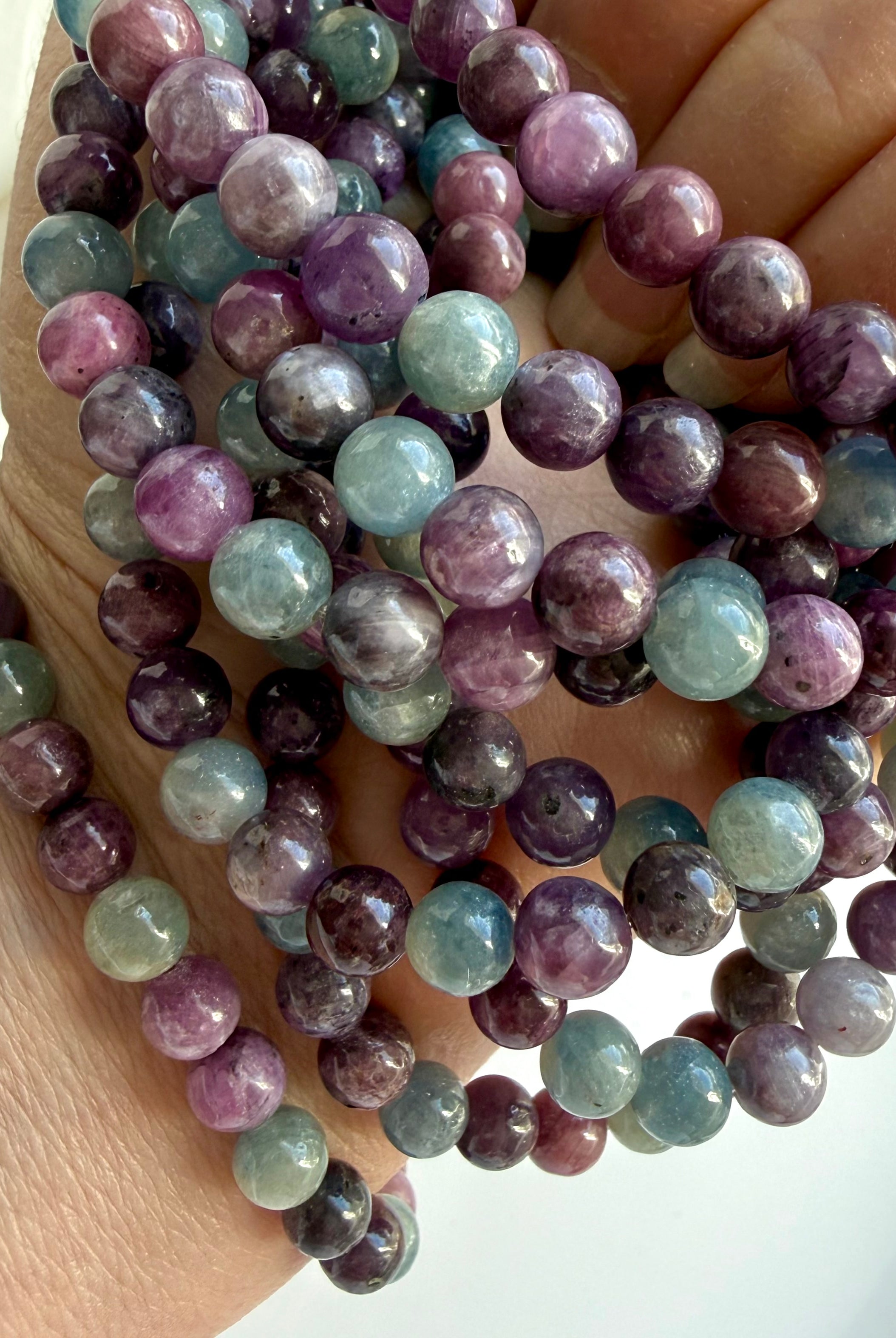 multiple Ruby Sapphire gemstone bracelets showing vibrant gemstone colors & natural ruby chatoyance