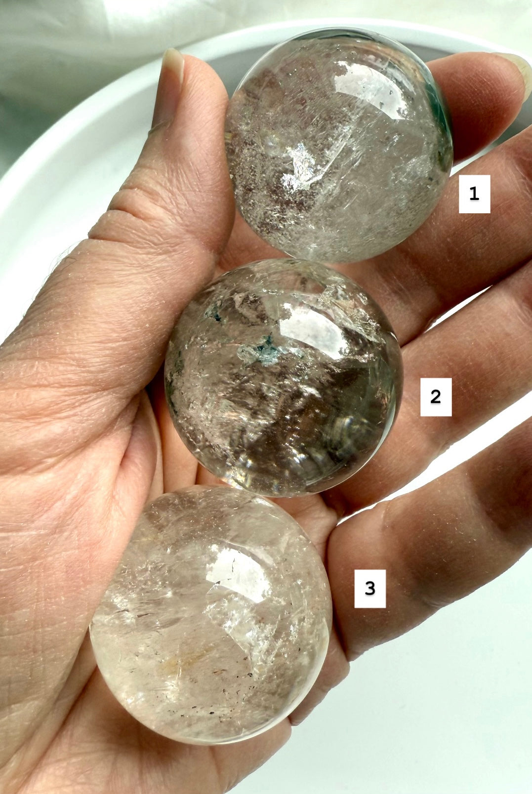 three garden quartz crystal spheres in hand – lodolite spheres for grounding energy and meditation