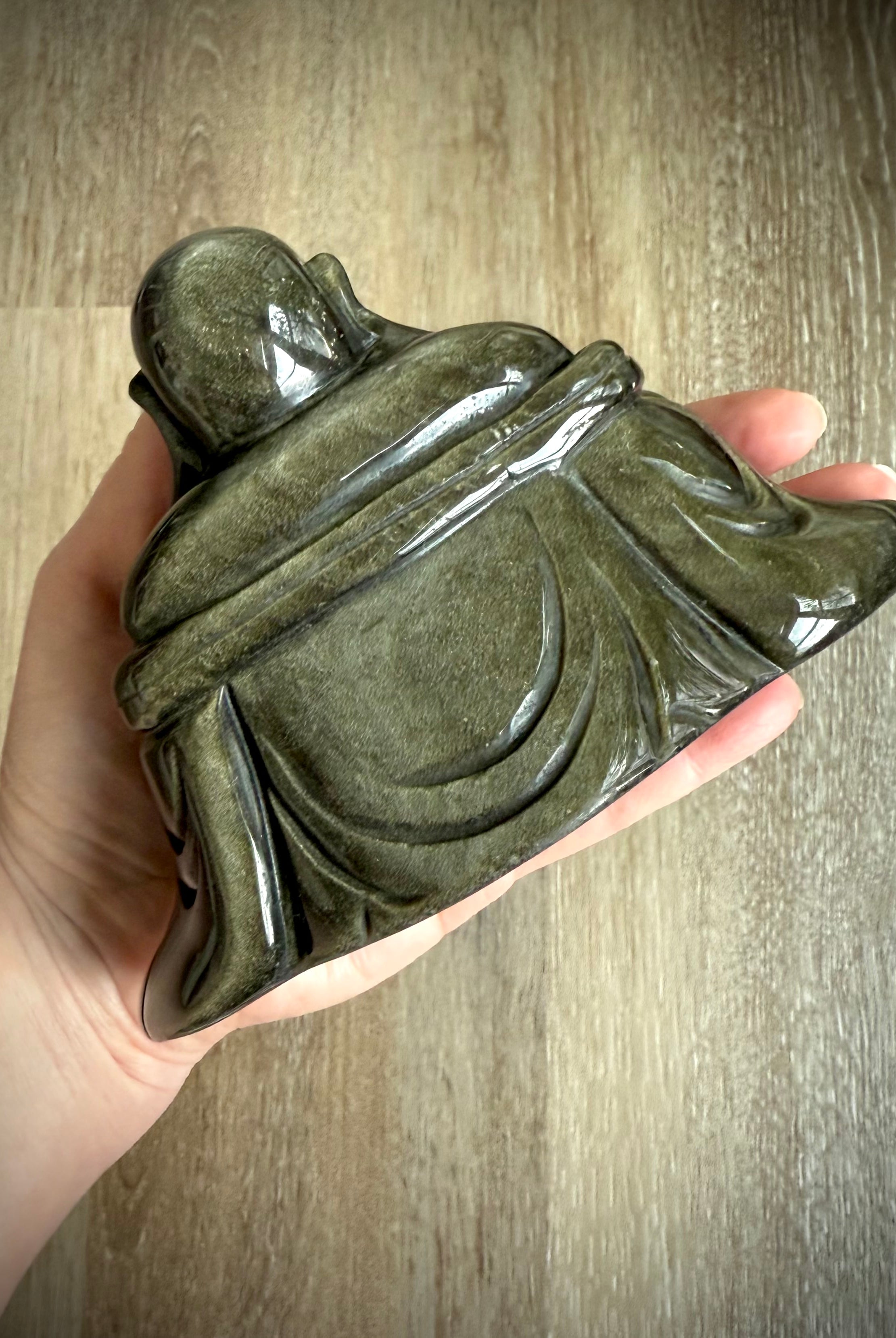 Back view of polished Golden Sheen Obsidian Buddha statue showing smooth robe details, crystal carving for grounding and spiritual energy