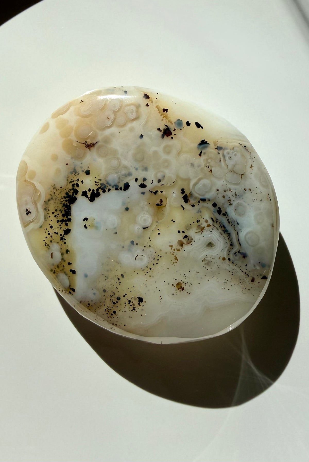 One-of-a-kind Dendritic Agate freeform in a flatlay, highlighting creamy white tones and natural landscape inclusions