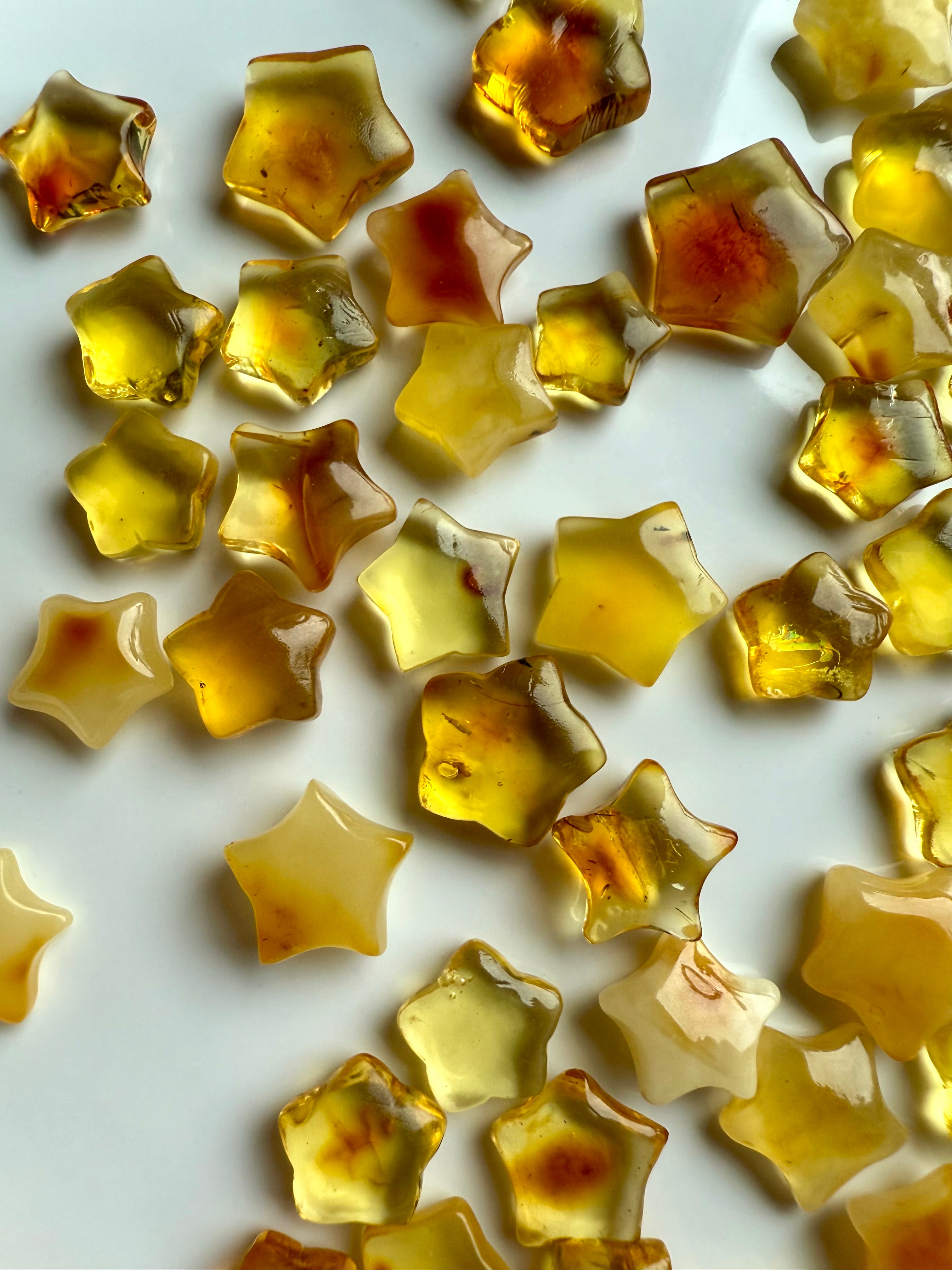 Polished Mini Amber Star crystals in golden honey tones for Solar Plexus chakra support