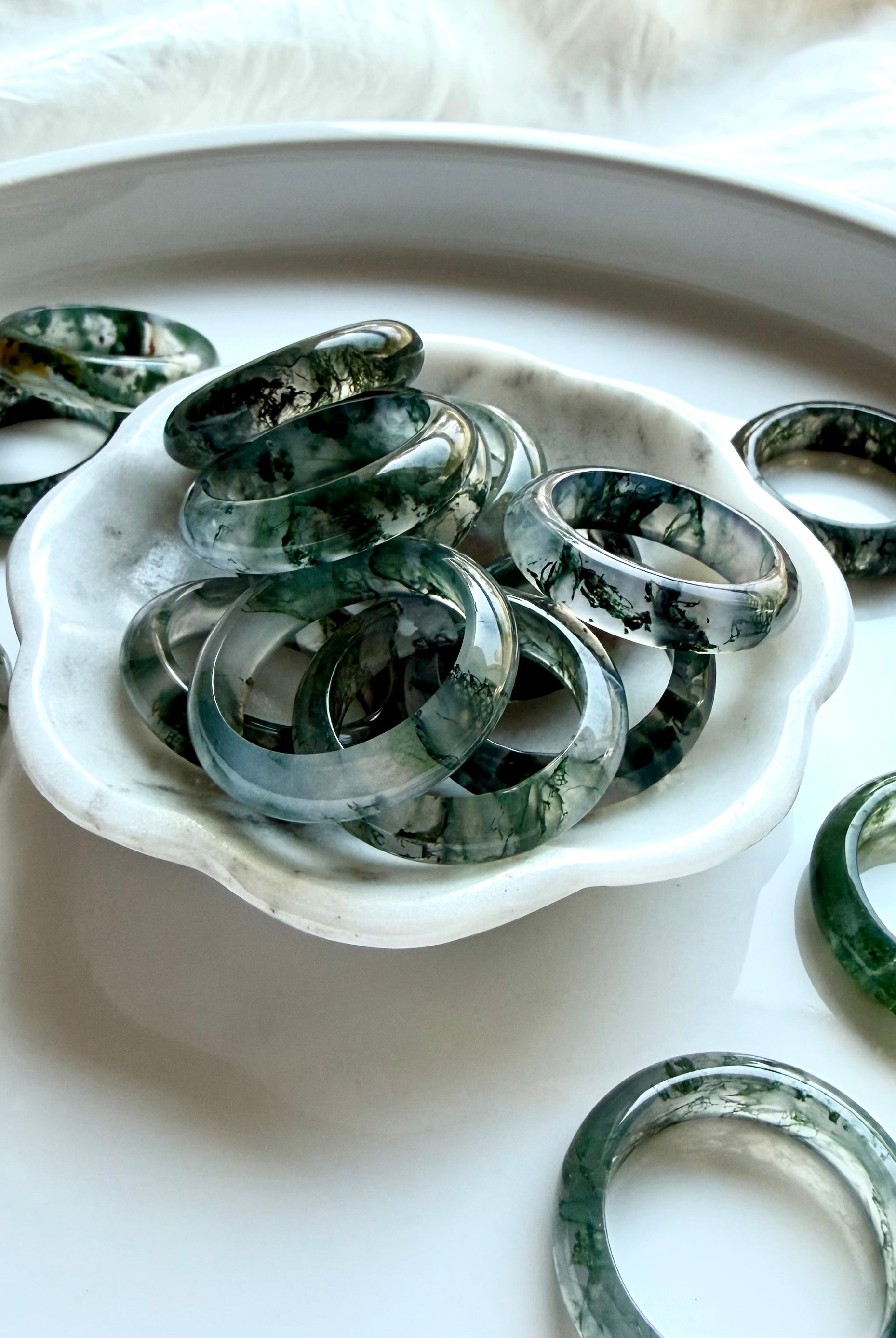 moss agate band rings styled together showing natural dendritic inclusions and polished shine, grounding crystal rings for everyday wear