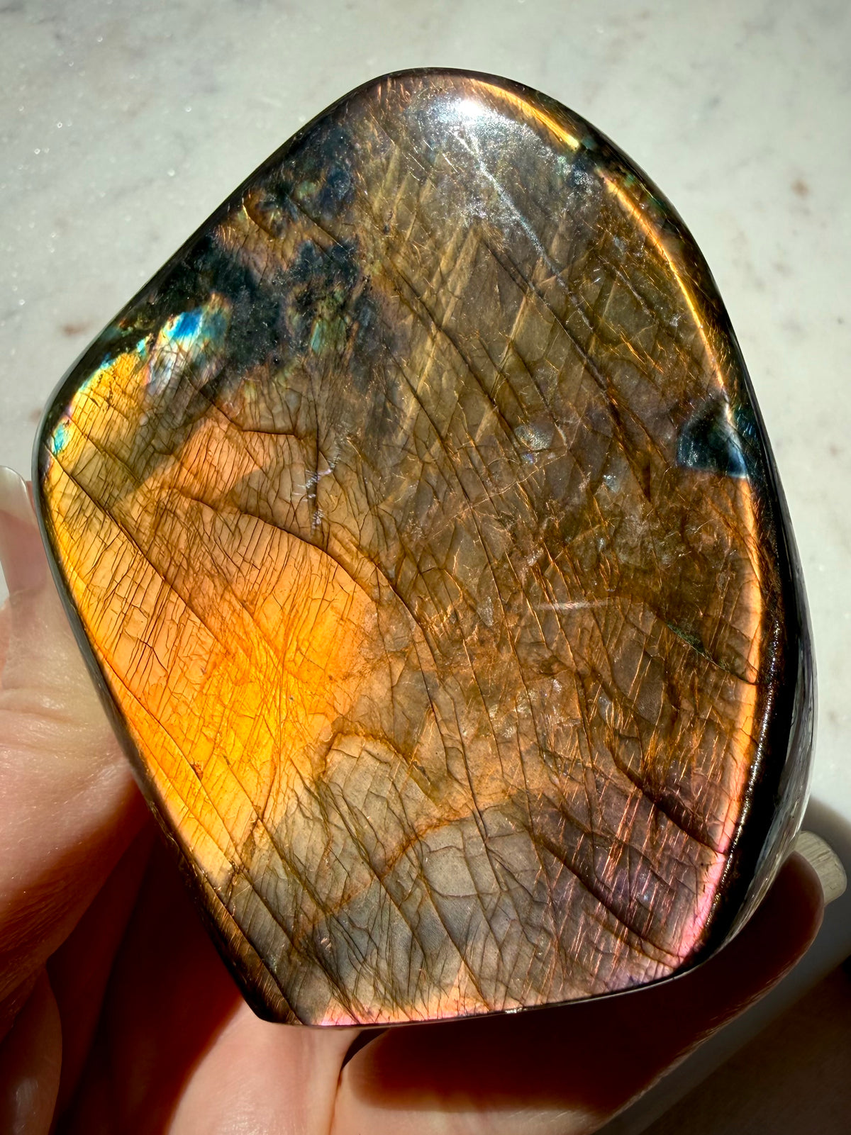 Madagascar Labradorite freeform showing coppery orange flash and dramatic natural mineral patterning