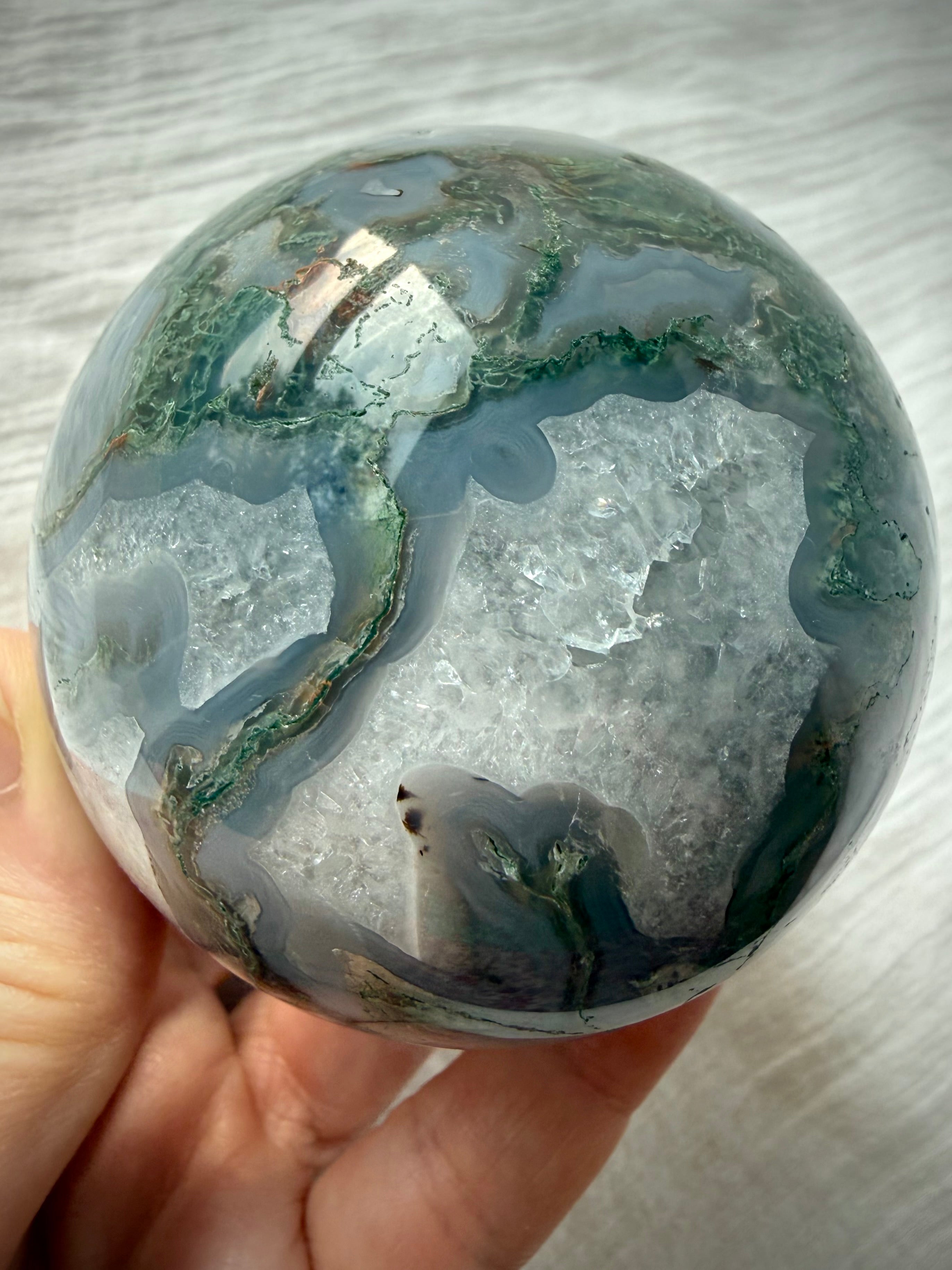 Dendritic Moss Agate crystal ball with sweeping green moss inclusions, gray chalcedony banding and polished finish
