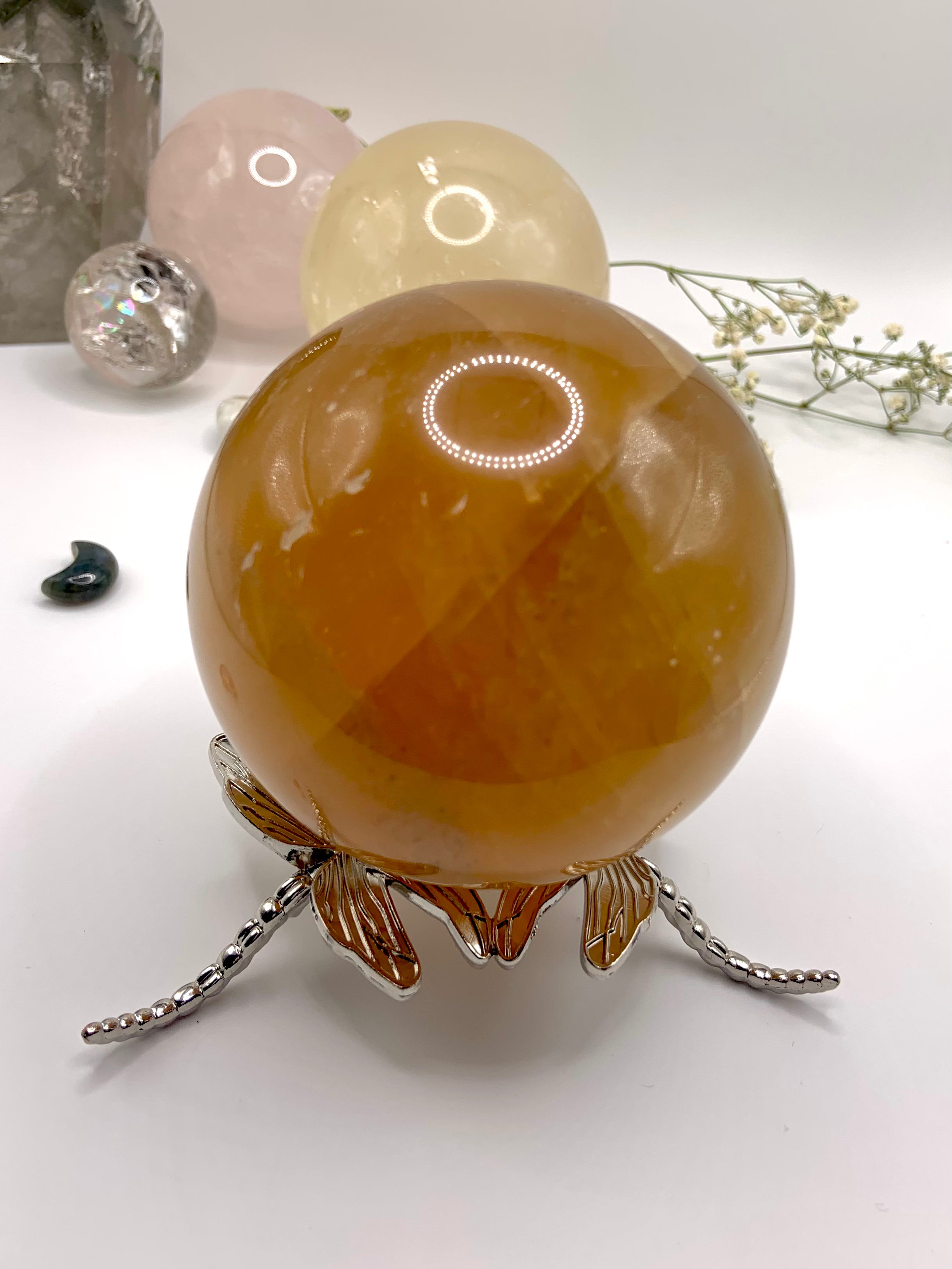 The larger dragonfly crystal ball stand shown with a 80mm honey calcite sphere