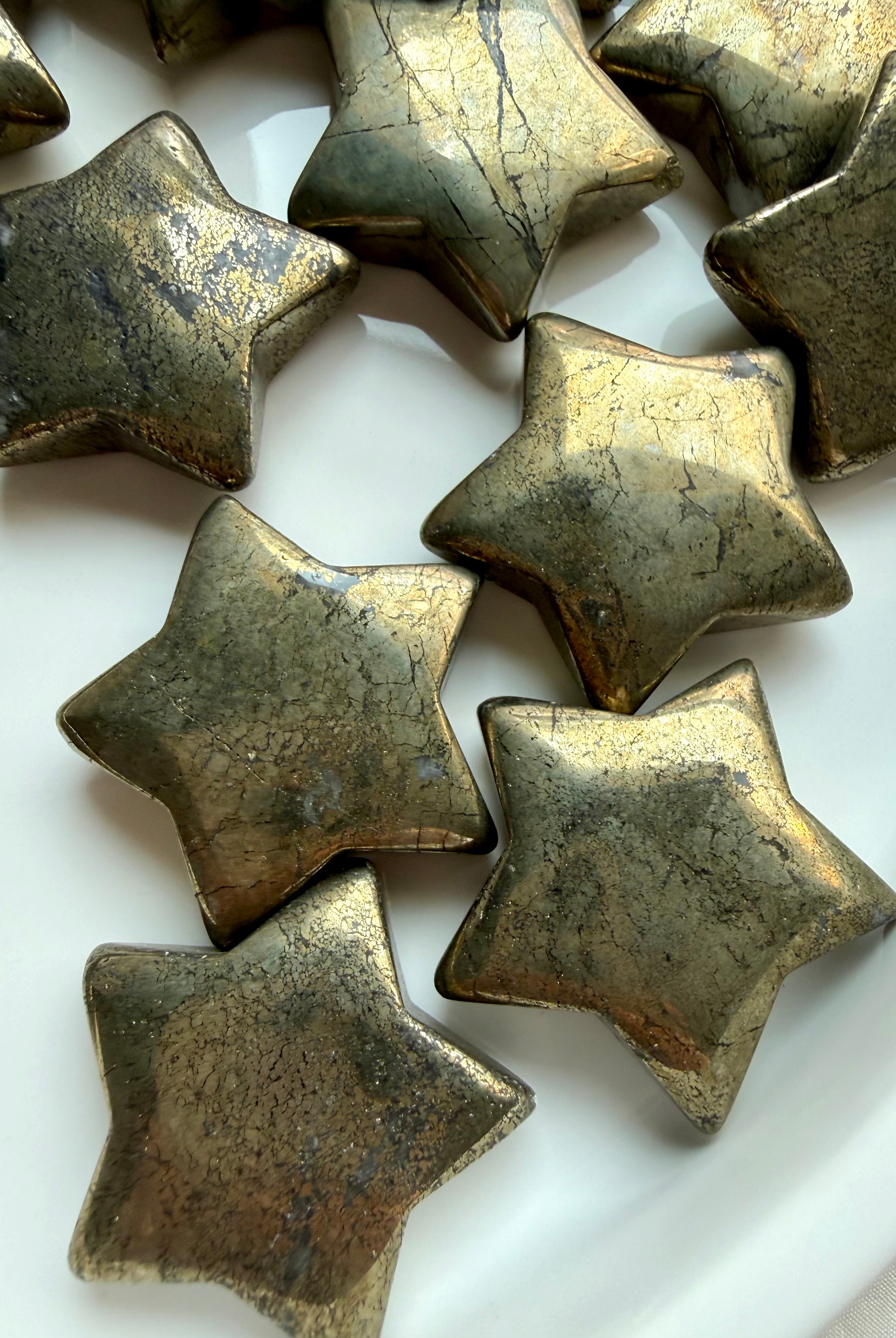 Pyrite crystal stars with shimmering metallic gold surfaces for confidence, motivation and success