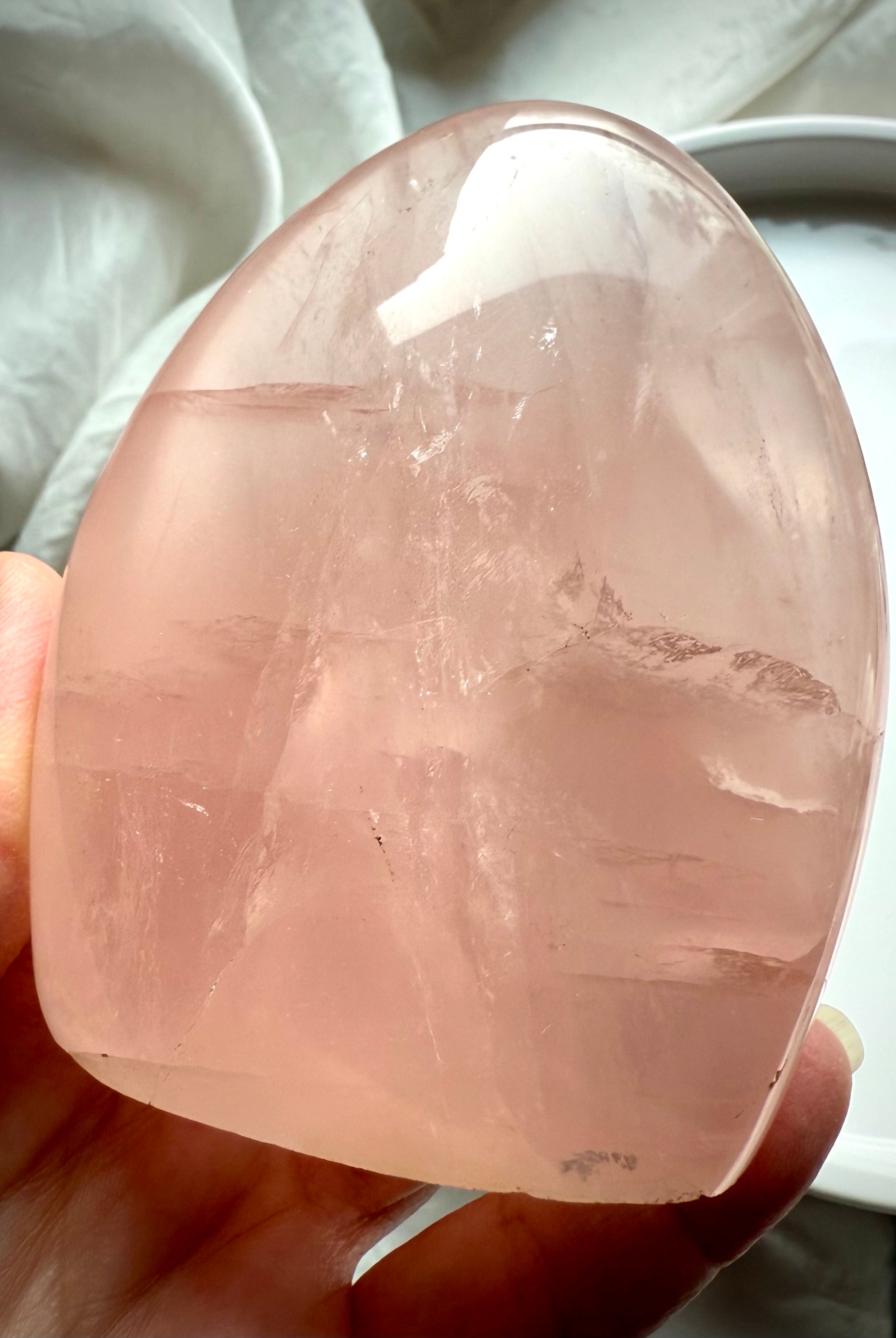 Luminous Rose Quartz freeform with transparent blush pink crystal and elegant sculptural display shape