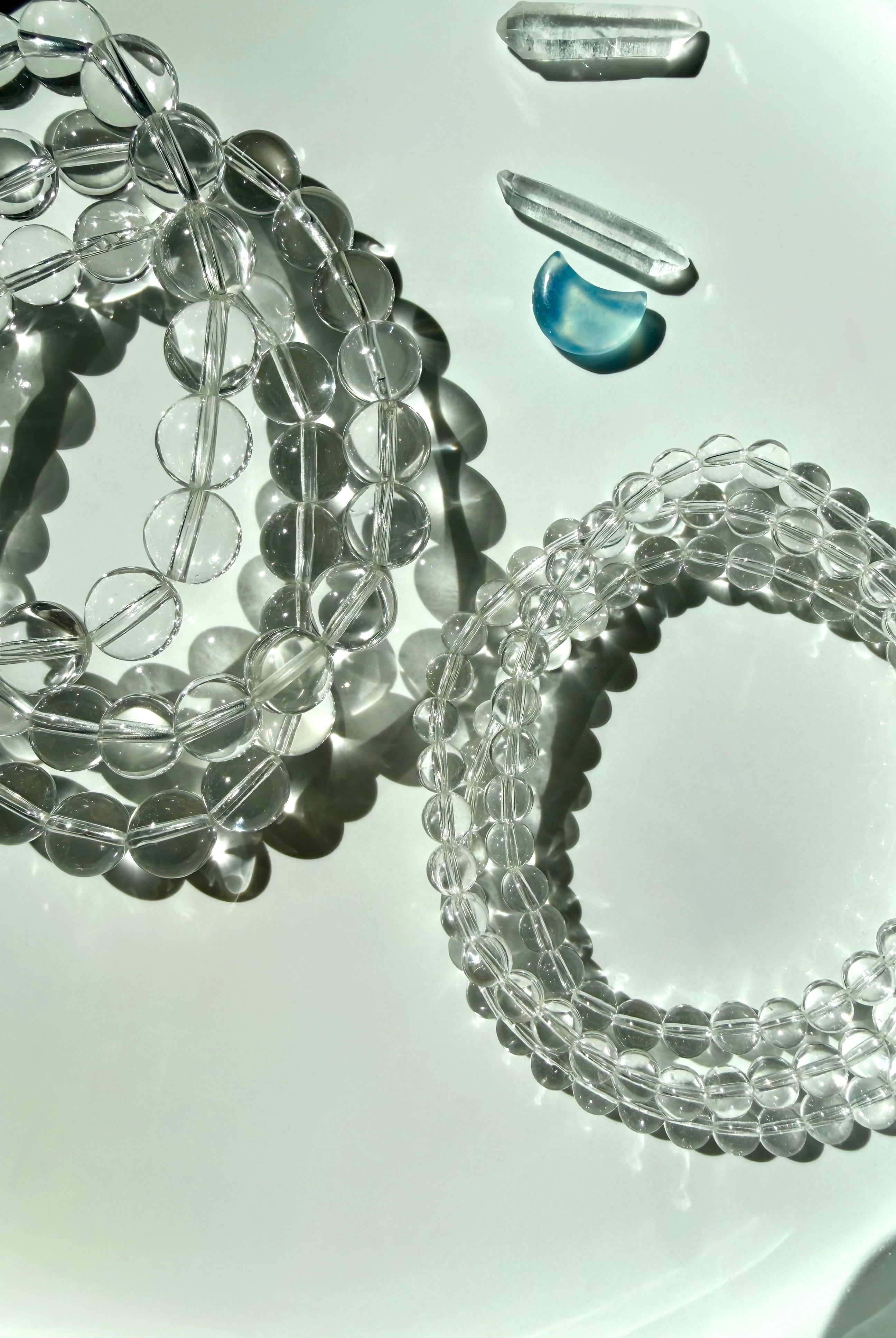 Clear Quartz bracelets with transparent crystal beads with exceptional natural clarity photographed in bright sunlight