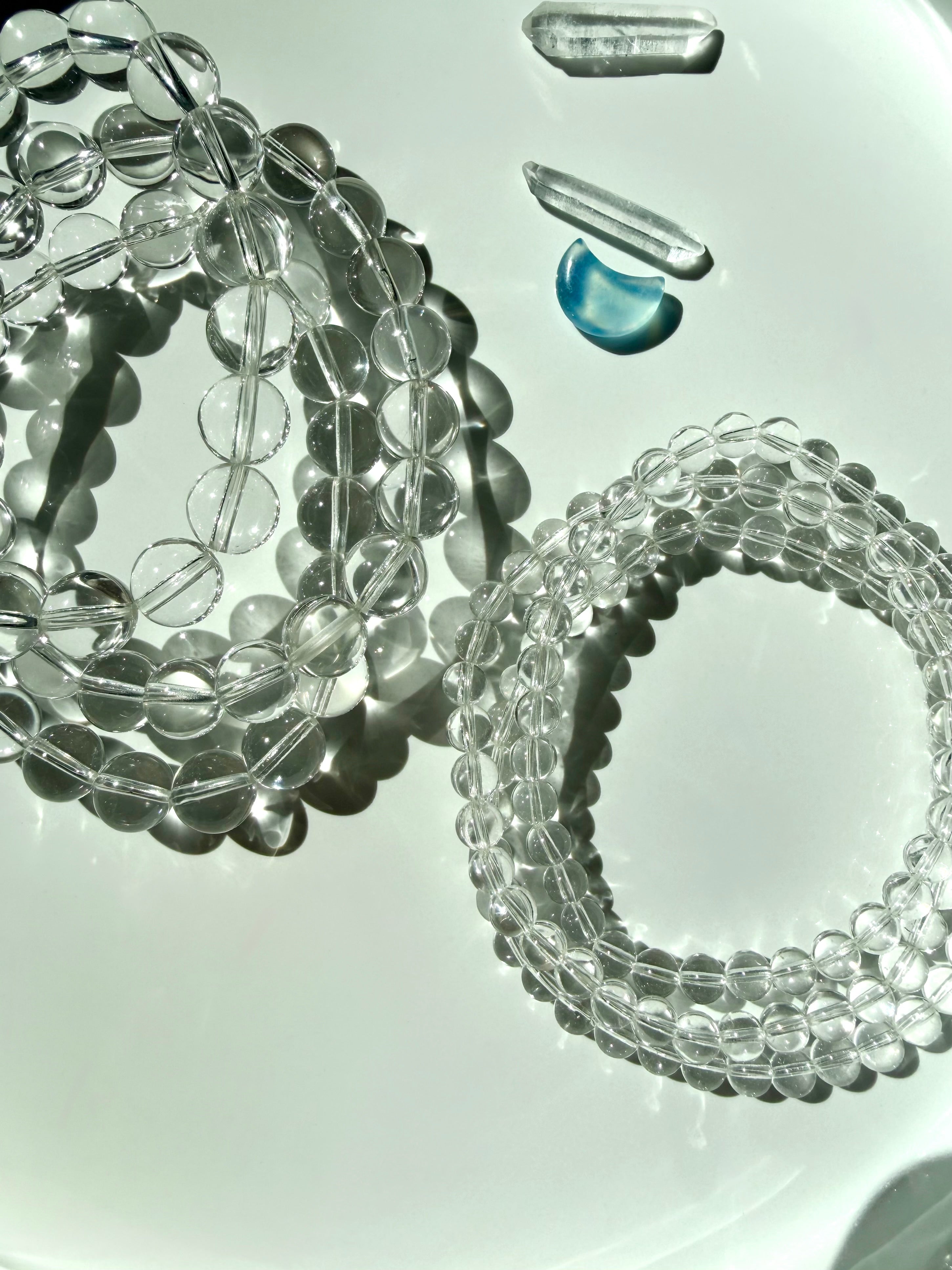 Clear Quartz bracelets with transparent crystal beads with exceptional natural clarity photographed in bright sunlight