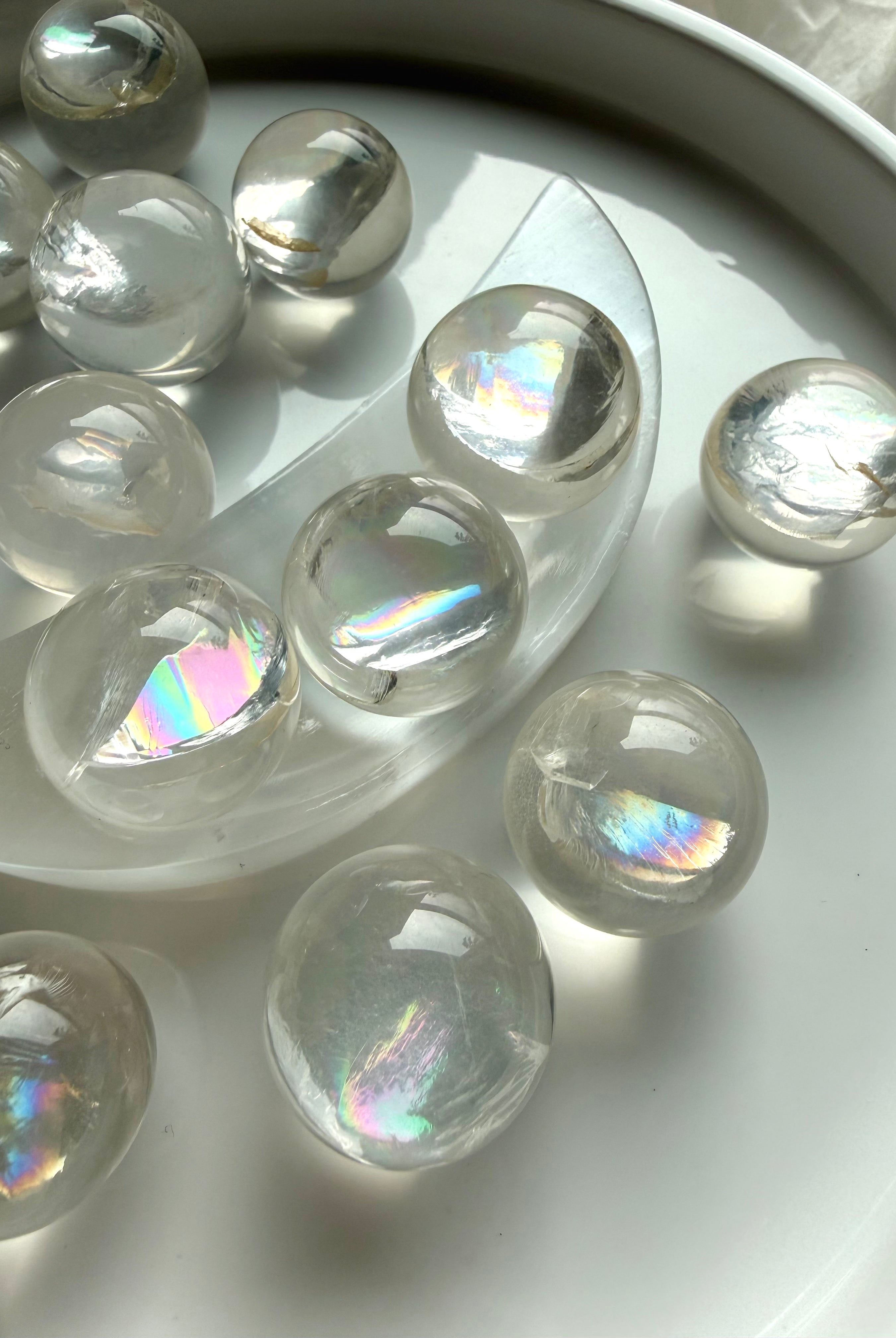 Rainbow girasol quartz mini sphere with silvery rainbow sheen under natural light, high-vibration meditation crystal