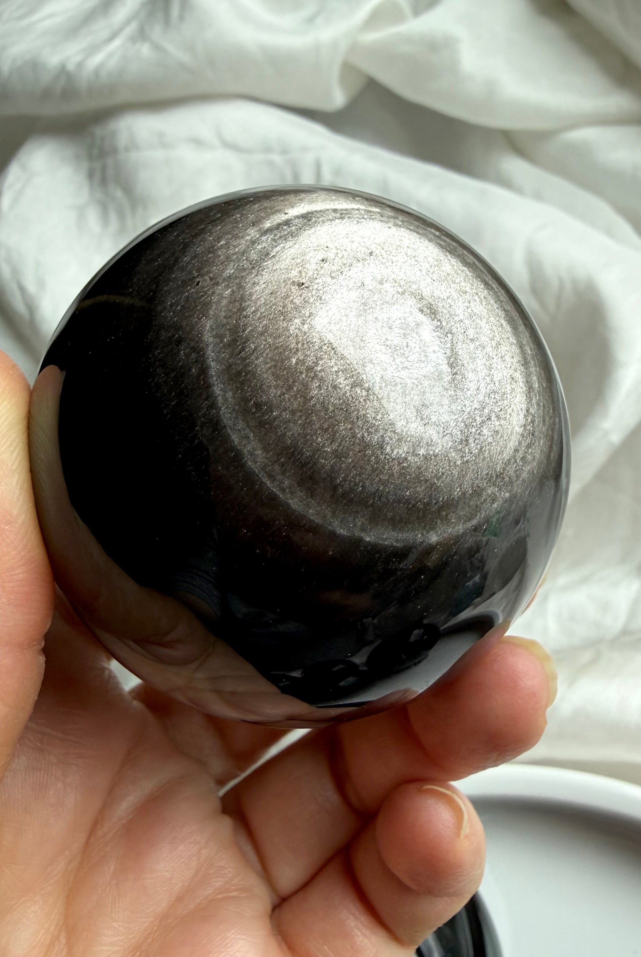 Silver Sheen Obsidian crystal ball with radiant silver glow — grounding and protective gemstone sphere