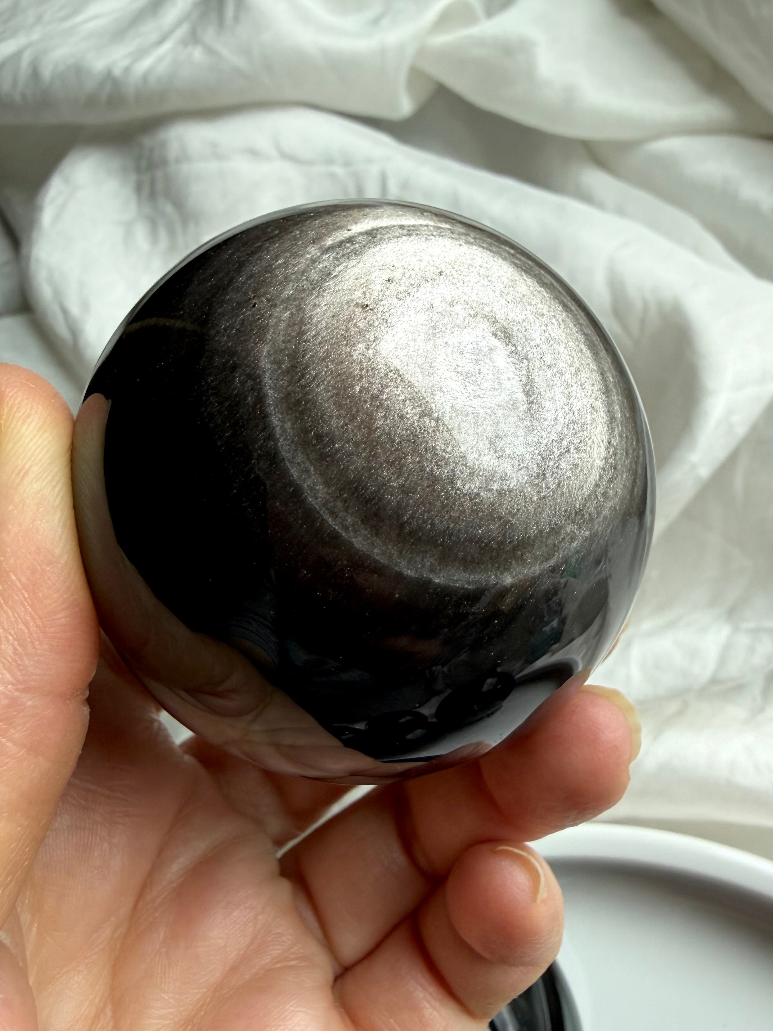 Silver Sheen Obsidian crystal ball with radiant silver glow — grounding and protective gemstone sphere
