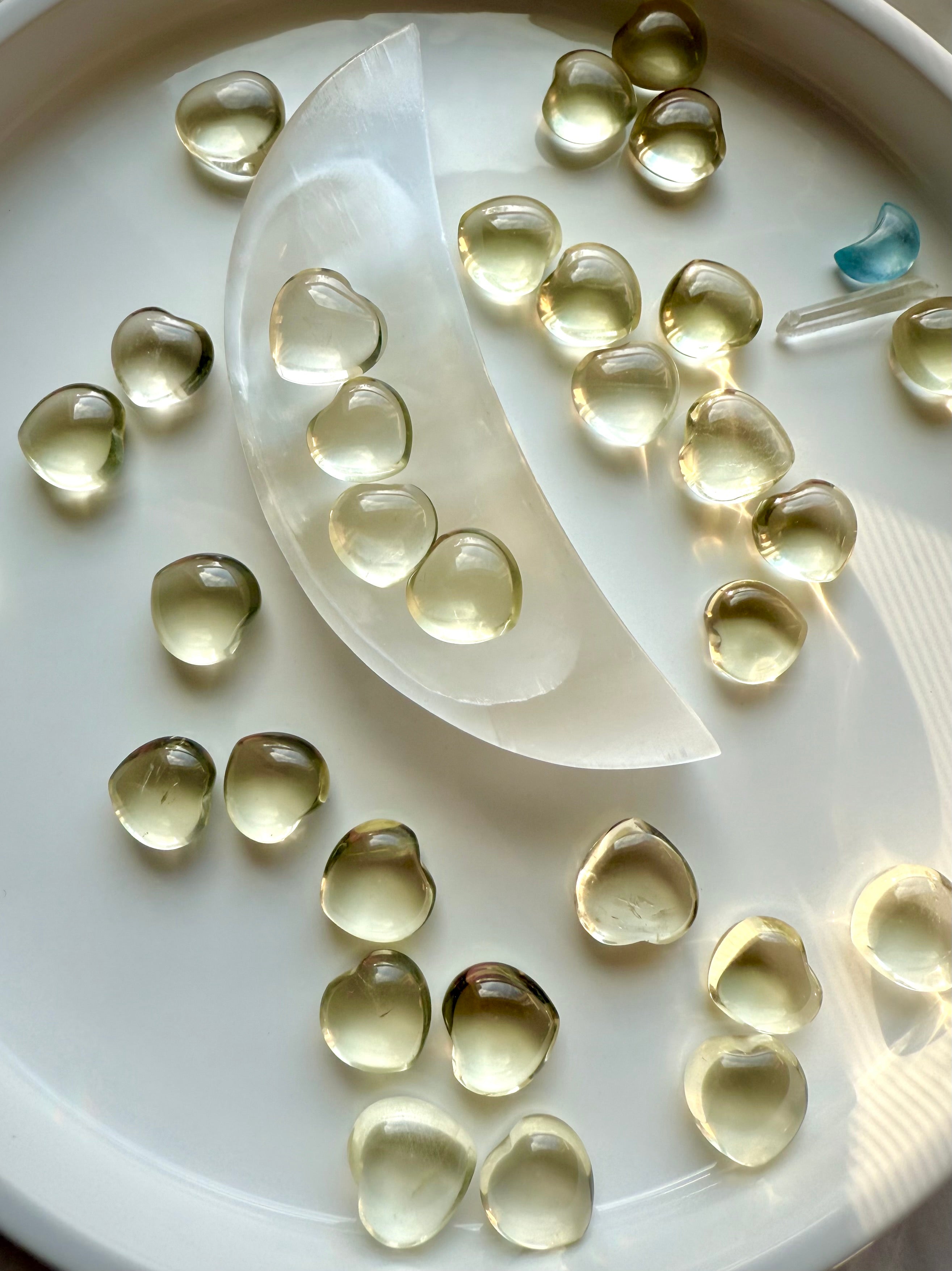 Mini Lemon Citrine heart crystals arranged in a selenite moon bowl, polished yellow citrine hearts for joy, confidence, and Solar Plexus Chakra healing