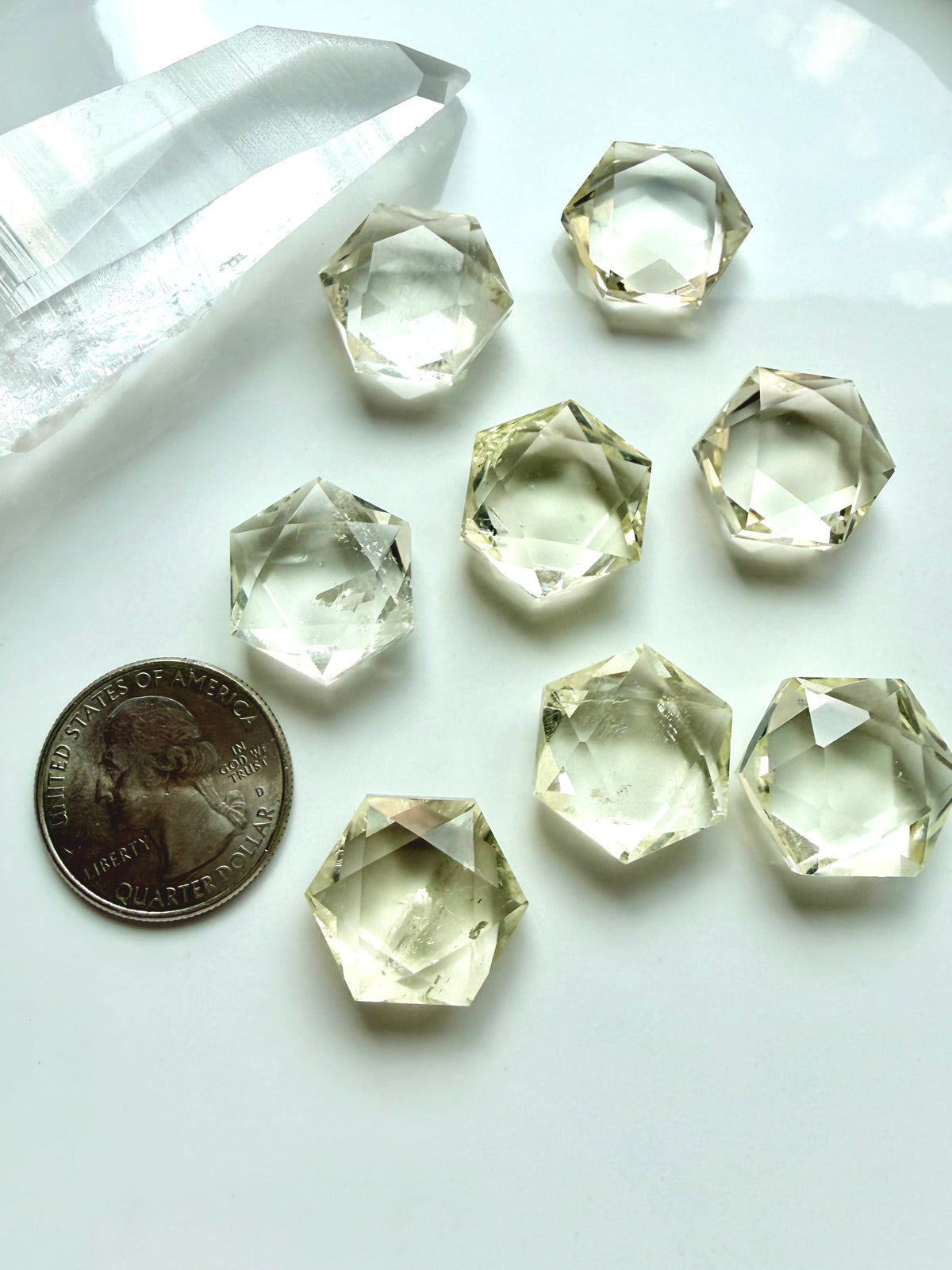 Mini Citrine hexagons beside a coin showing the size of these faceted sacred geometry crystals