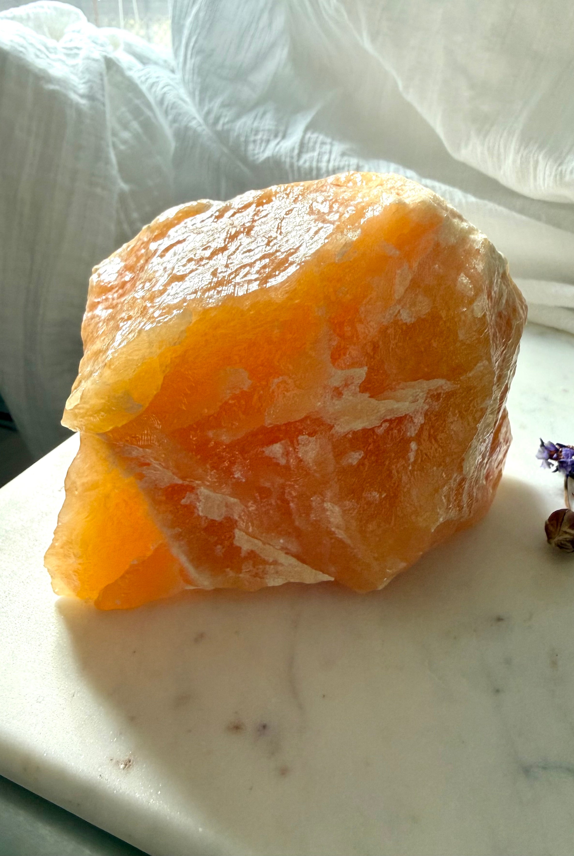 Large Orange Calcite display piece from Mexico with glowing translucency, natural formations, and self-standing crystal shape
