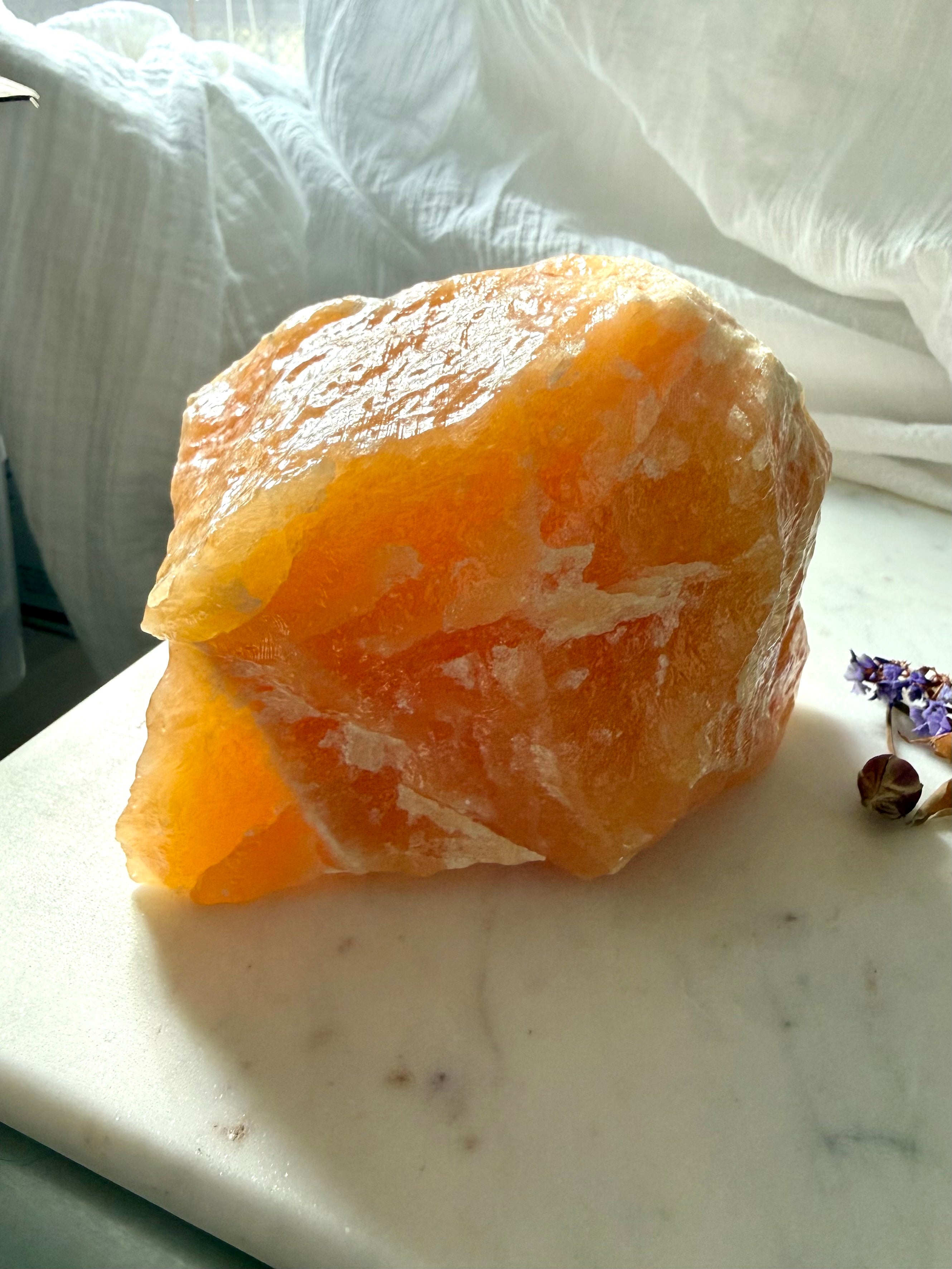 Large Orange Calcite display piece from Mexico with glowing translucency, natural formations, and self-standing crystal shape