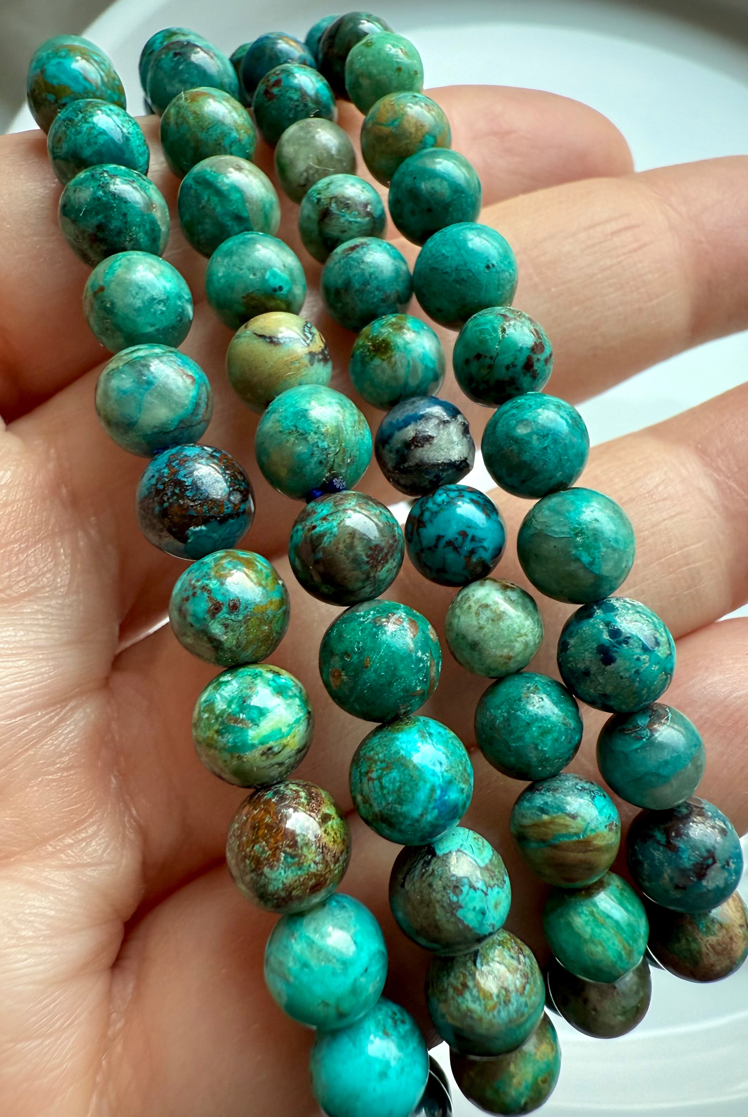 Close-up of Chrysocolla Shattuckite beads revealing intricate natural patterns, handmade crystal bracelet for clarity and insight
