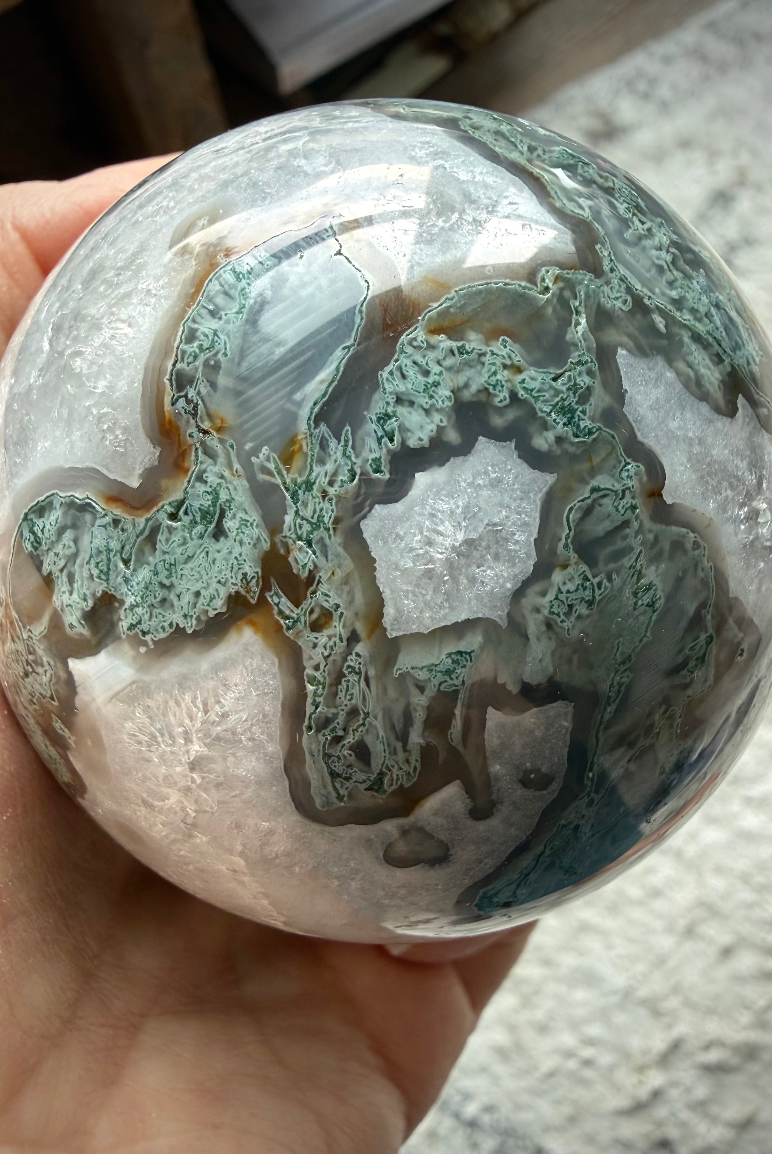 Large Moss Agate display sphere with natural crystal formations for meditation and sacred spaces