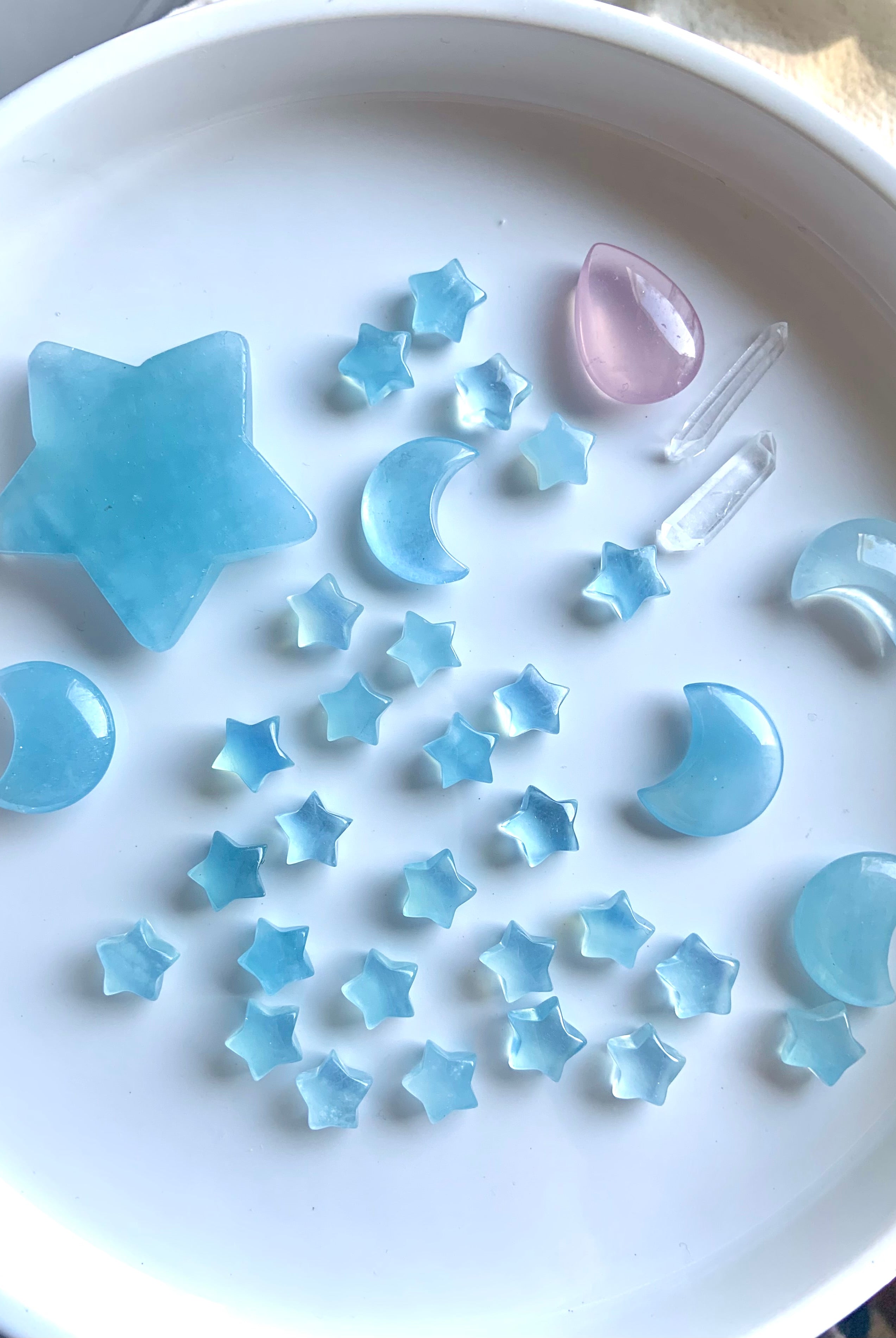 Assorted Aquamarine crystal stars and moons on white background