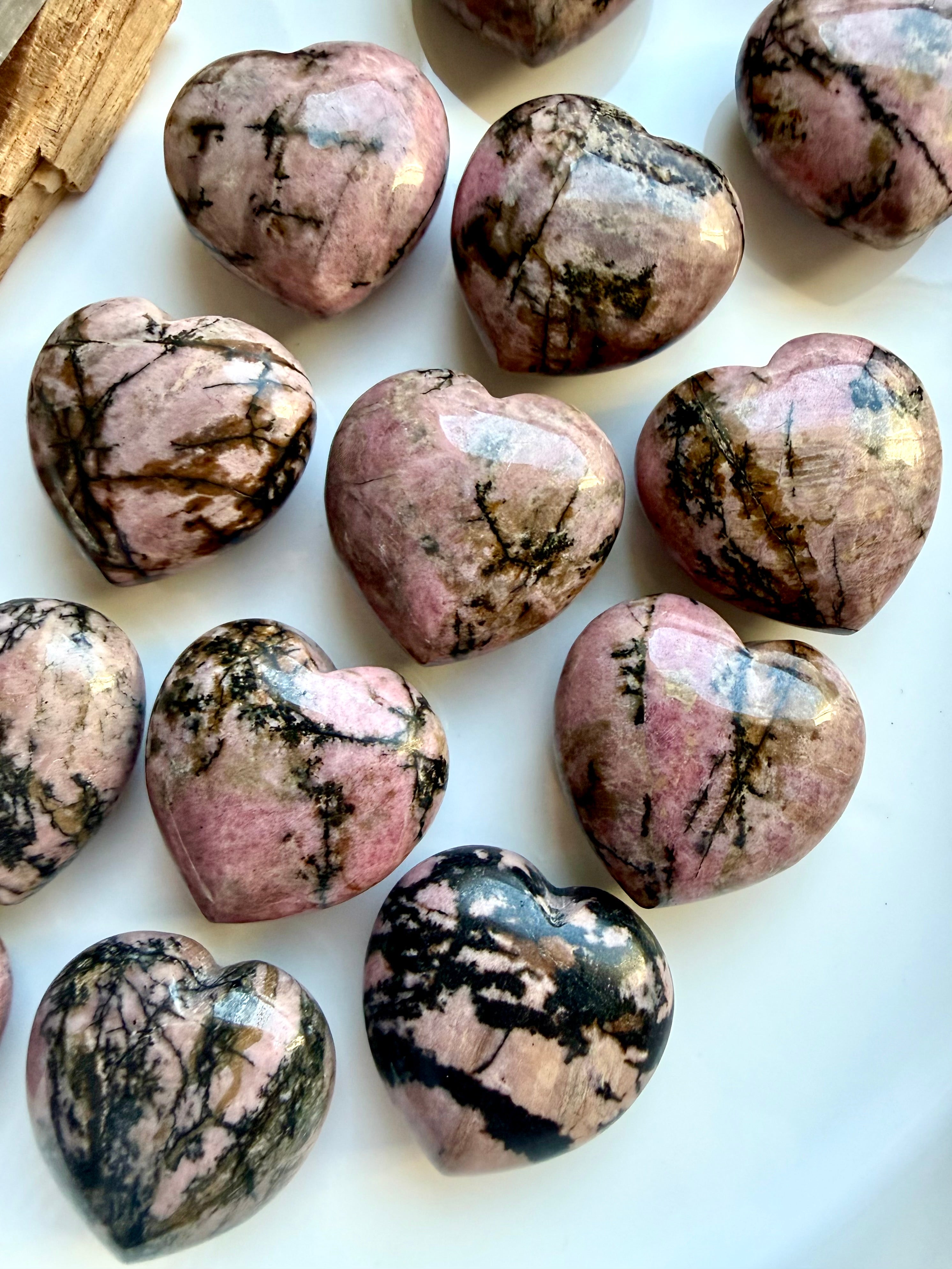 Polished Rhodonite heart carvings with pink stone and contrasting black manganese veining