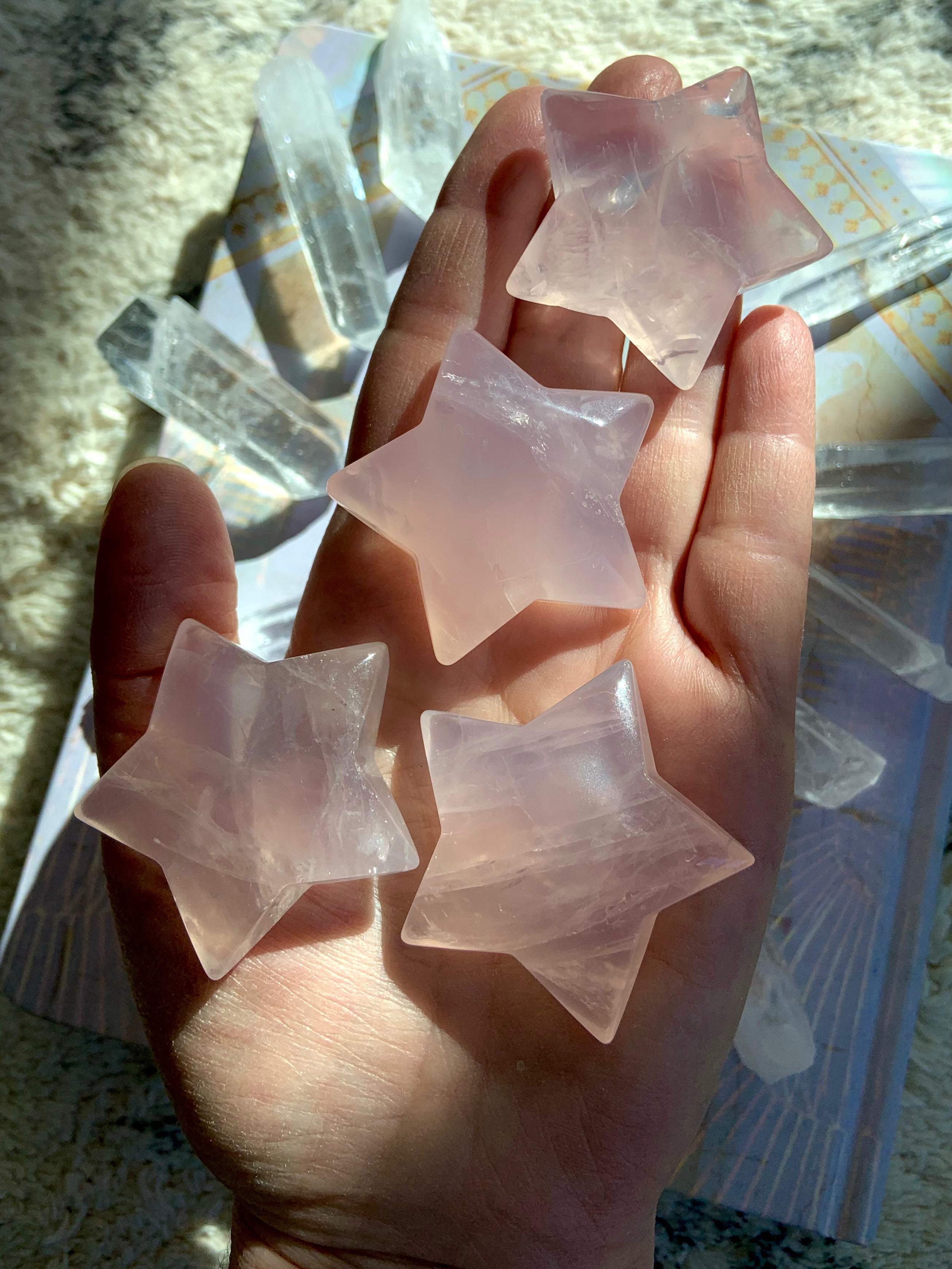 Polished Mozambique Rose Quartz Star carving shown in hand — soft pink Heart Chakra crystal, approx. 2 inches, for love, calm, and healing.
