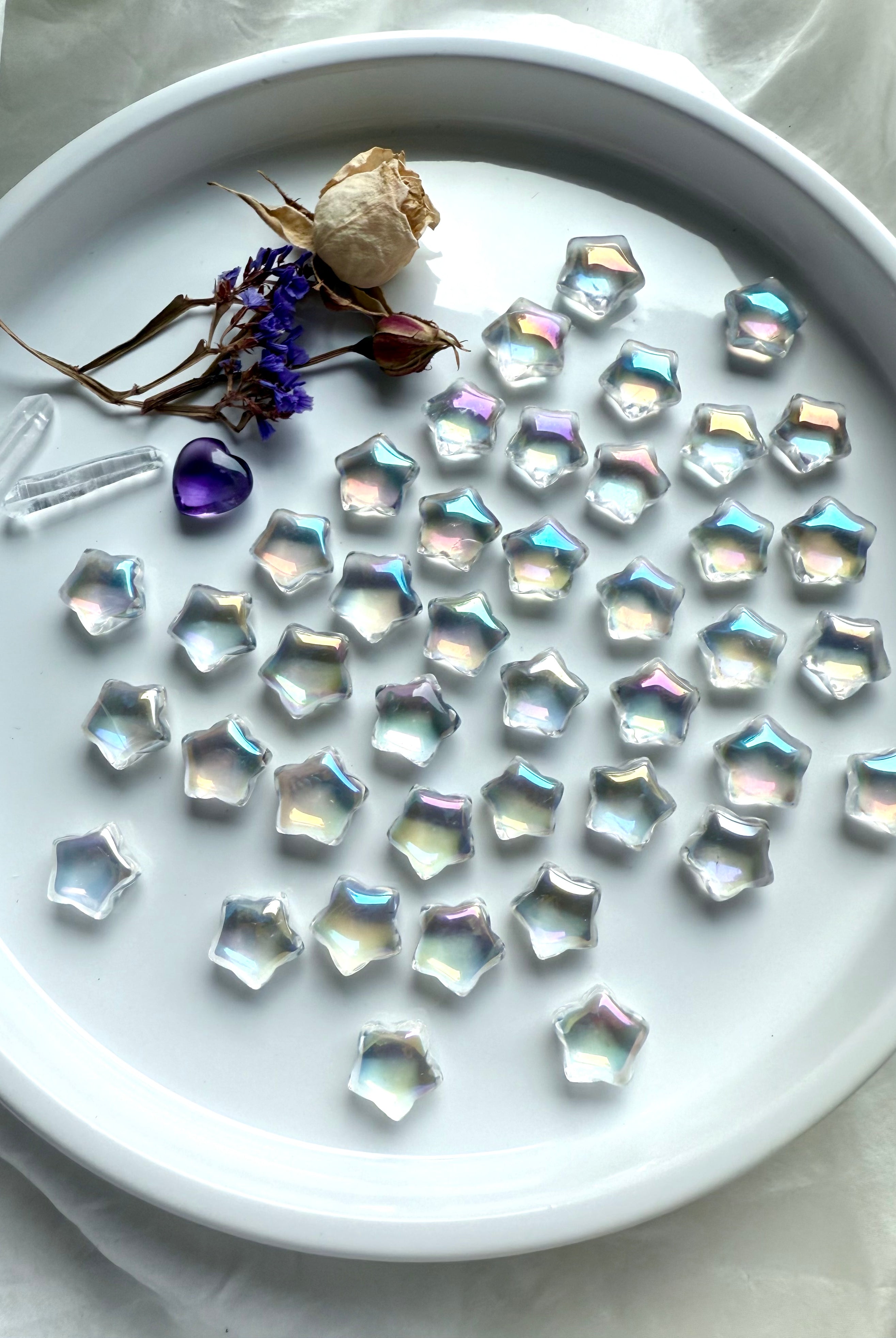 Mini Aura Quartz crystal stars with iridescent rainbow sheen, polished star carvings for healing, altar décor, crystal grids, and universal chakra energy.