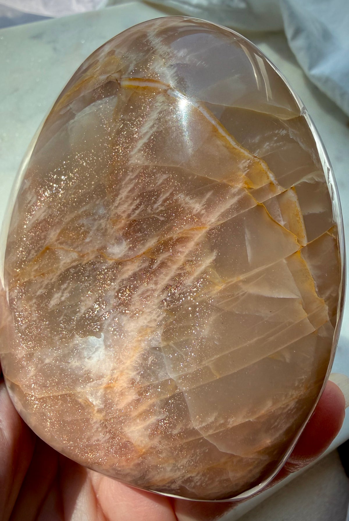 Peach Moonstone crystal showing warm peach color, natural inclusions and golden Sunstone shimmer