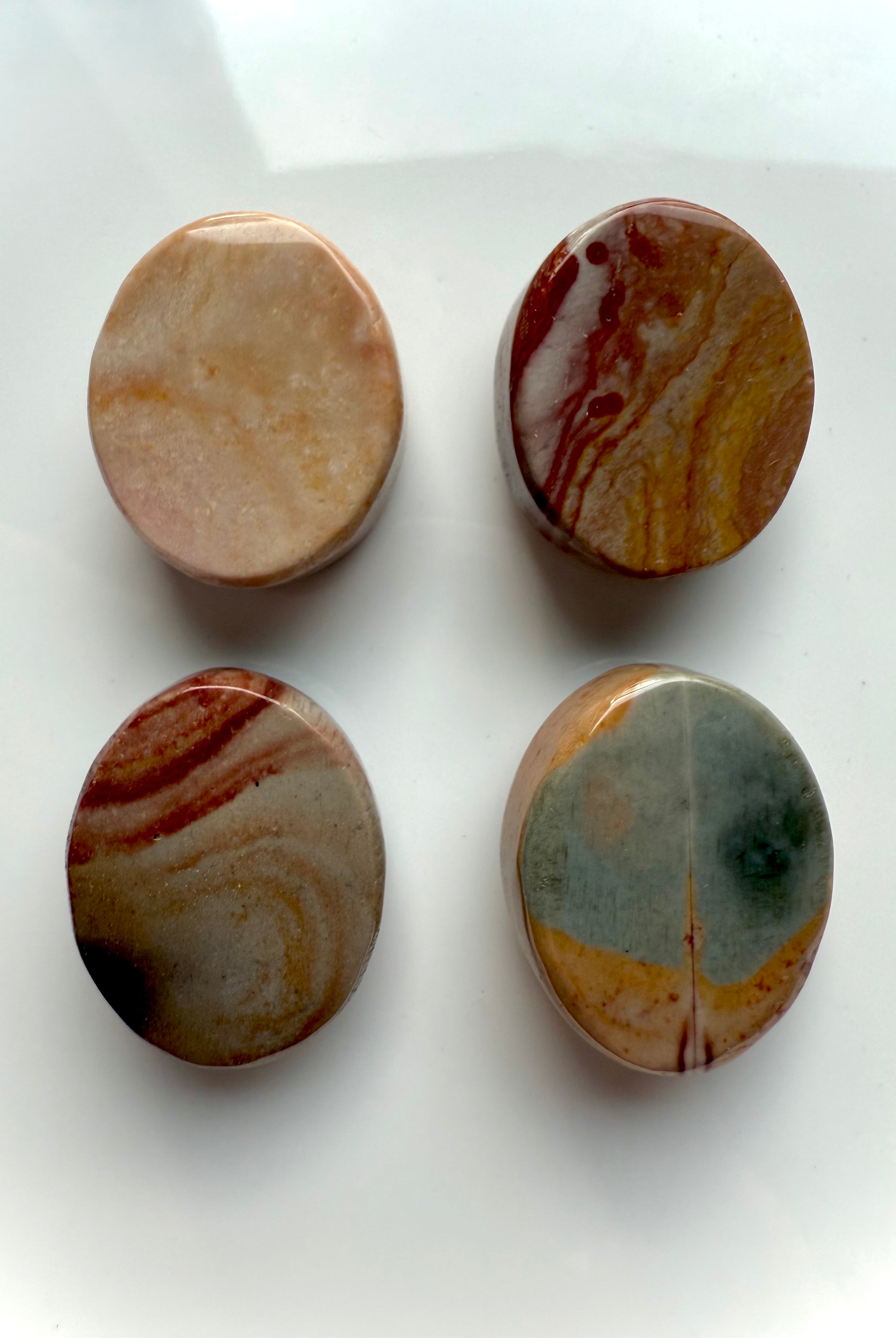 Back view of Polychrome Jasper cabochons showing natural patterns and color variations — polished crystal ovals for grounding and earthy energy work.