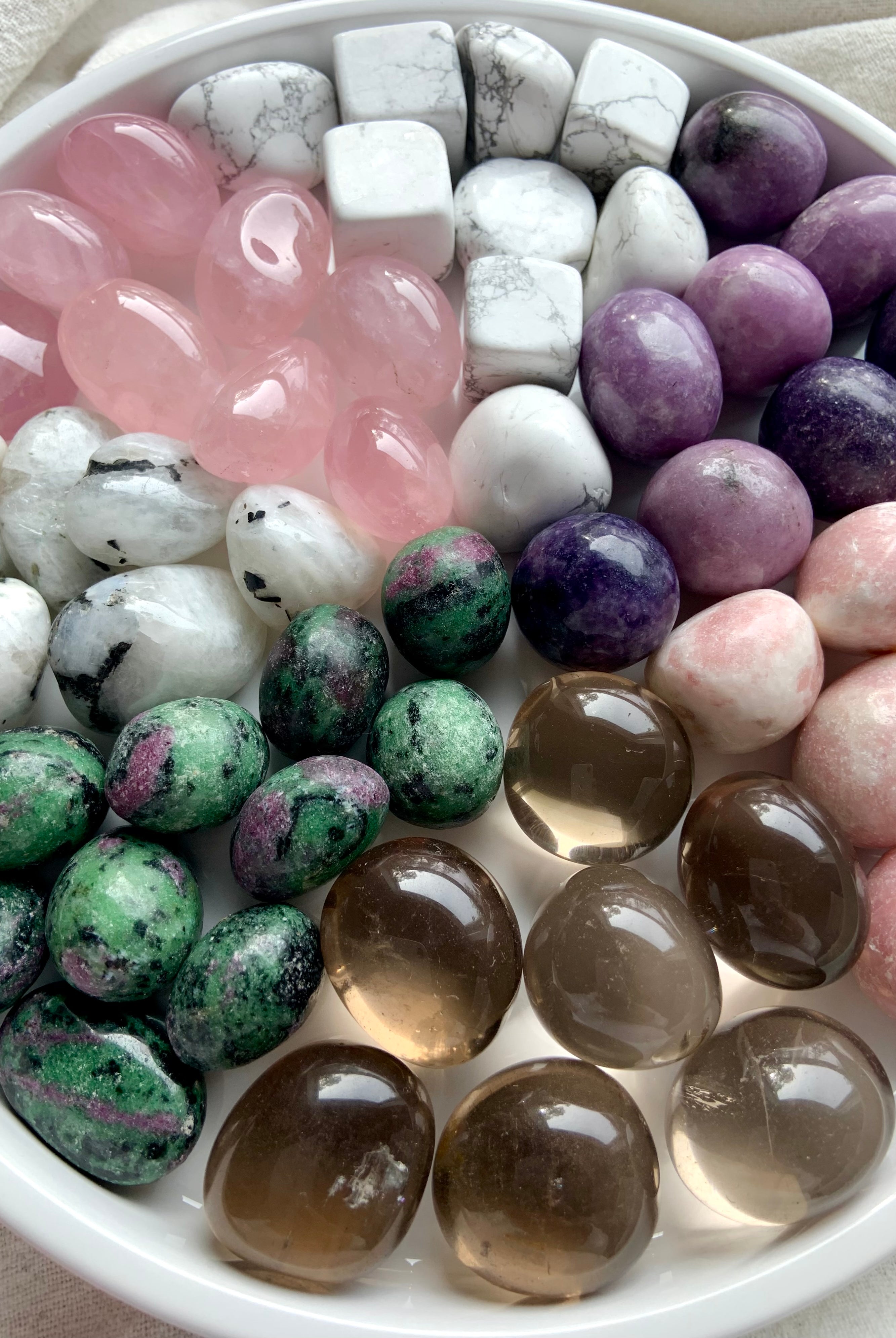 Healing crystals for grief & emotional support: rose quartz, howlite, lepidolite, moonstone, pink opal, smoky quartz, & ruby zoisite