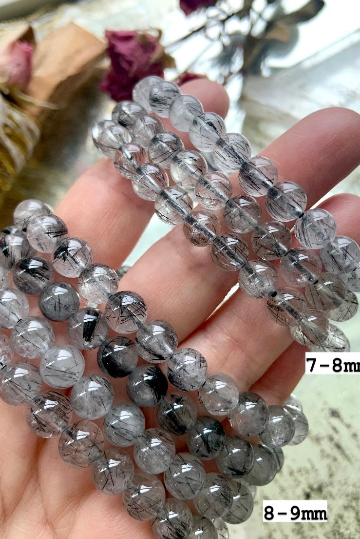 Stack of bracelets in two bead sizes (7–8mm and 8–9mm), split for easy size comparison, marked accordingly