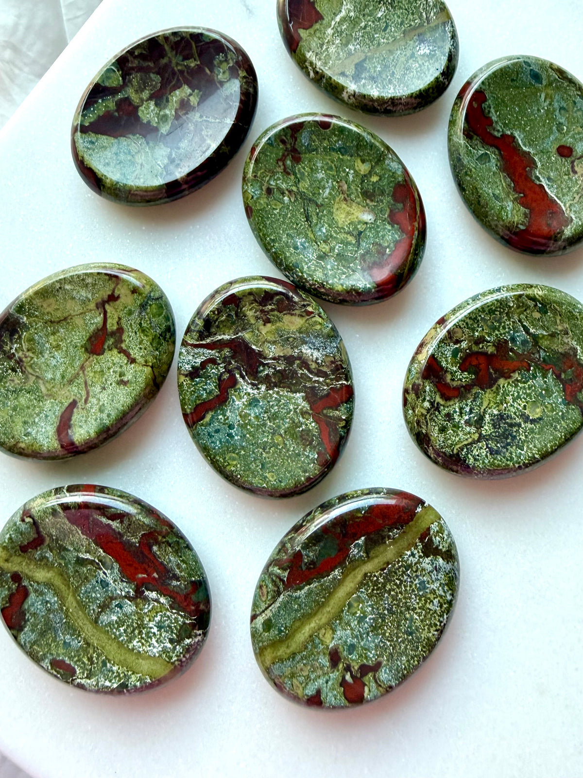 Natural Dragon Blood Stone worry stones displaying unique forest-green, olive and burgundy patterns with smooth polished surfaces